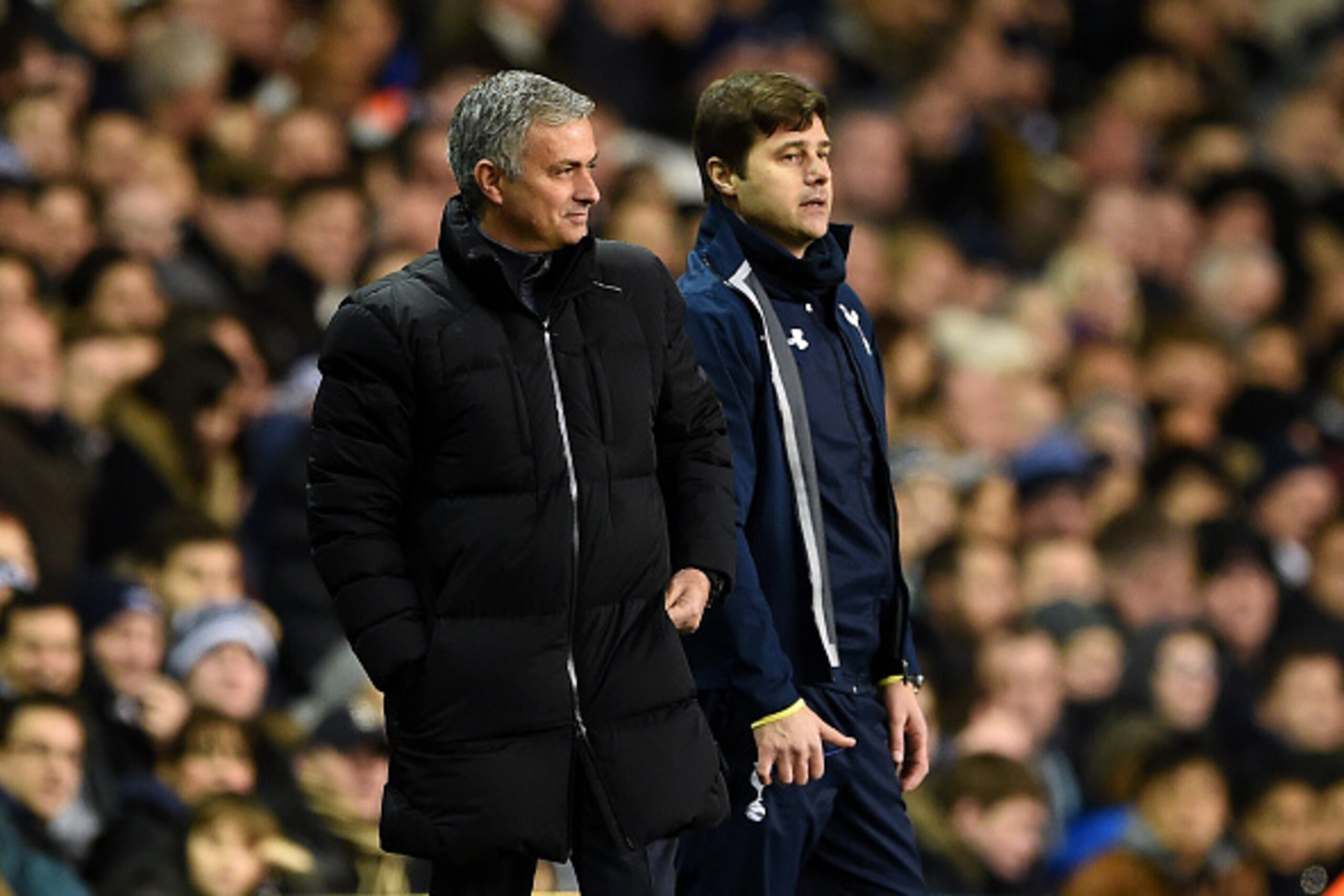 LONDON, ENGLAND - JANUARY 01:  Jose Mourinho, manager of Chelsea smiles as he stands next to Mauricio Pochettino, manager of Spurs during the Barclays Premier League match between Tottenham Hotspur and Chelsea at White Hart Lane on January 1, 2015 in Lond
