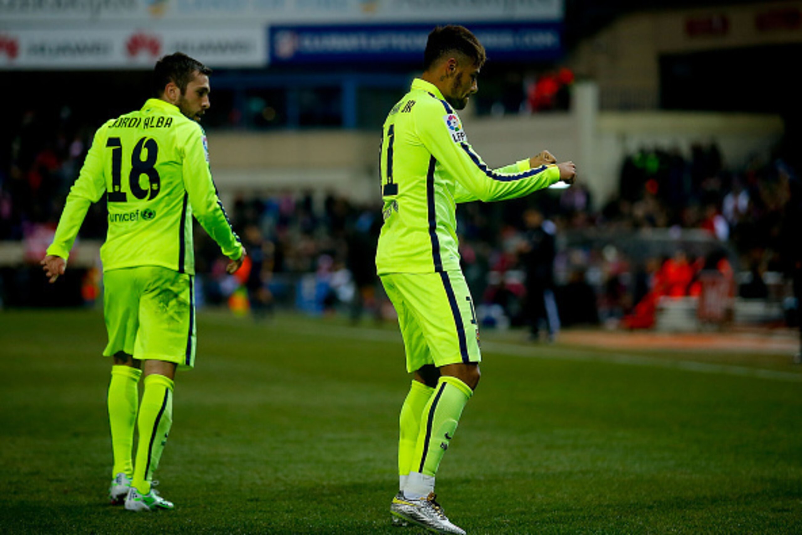 MADRID, SPAIN - JANUARY 28: Neymar JR. (R) of FC Barcelona celebrates scoring their third goal as is teammate Jordi Alba (L) looks to him during the Copa del Rey Round of 8 second leg match between Club Atletico de Madrid and FC Barcelona at Vicente Calde