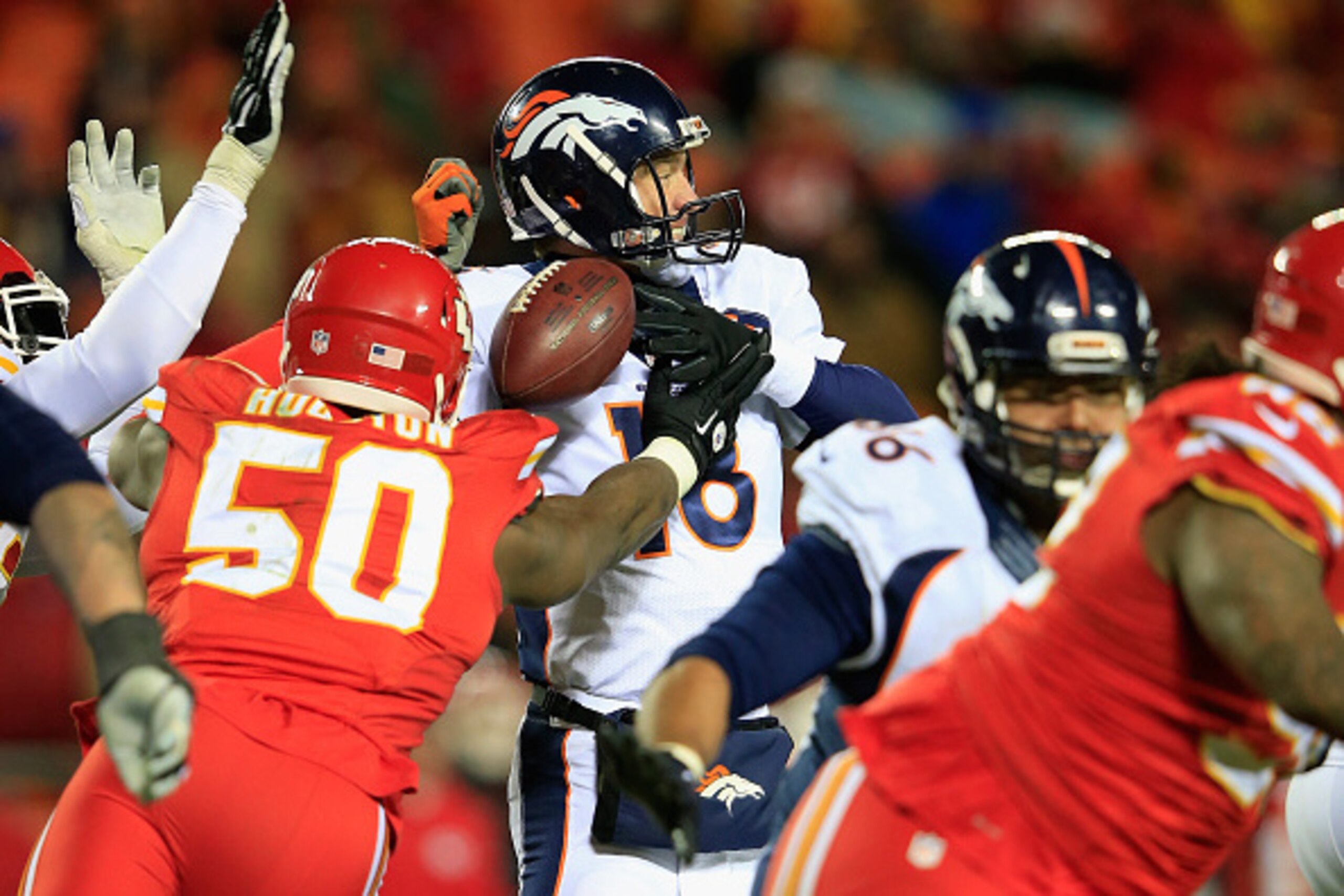 KANSAS CITY, MO - NOVEMBER 30:  Justin Houston #50 of the Kansas City Chiefs forces a fumble on  Peyton Manning #18 of the Denver Broncos during the third quarter at Arrowhead Stadium on November 30, 2014 in Kansas City, Missouri.  (Photo by Jamie Squire/