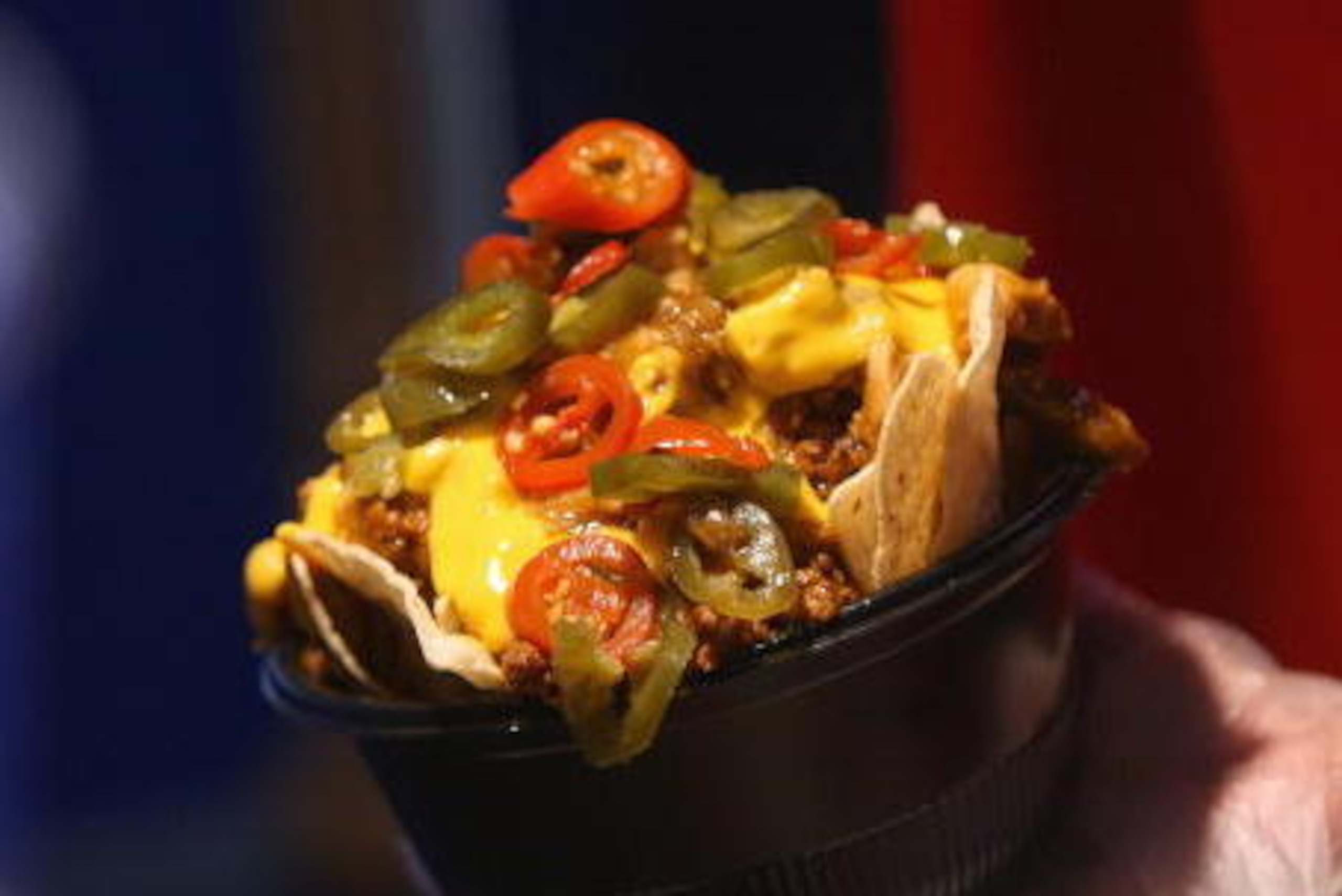 MILWAUKEE - APRIL 10:  A worker prepares nachos for a customer before the Opening Day game between the Milwaukee Brewers and the Chicago Cubs on April 10, 2009 at Miller Park in Milwaukee, Wisconsin. (Photo by Jonathan Daniel/Getty Images)