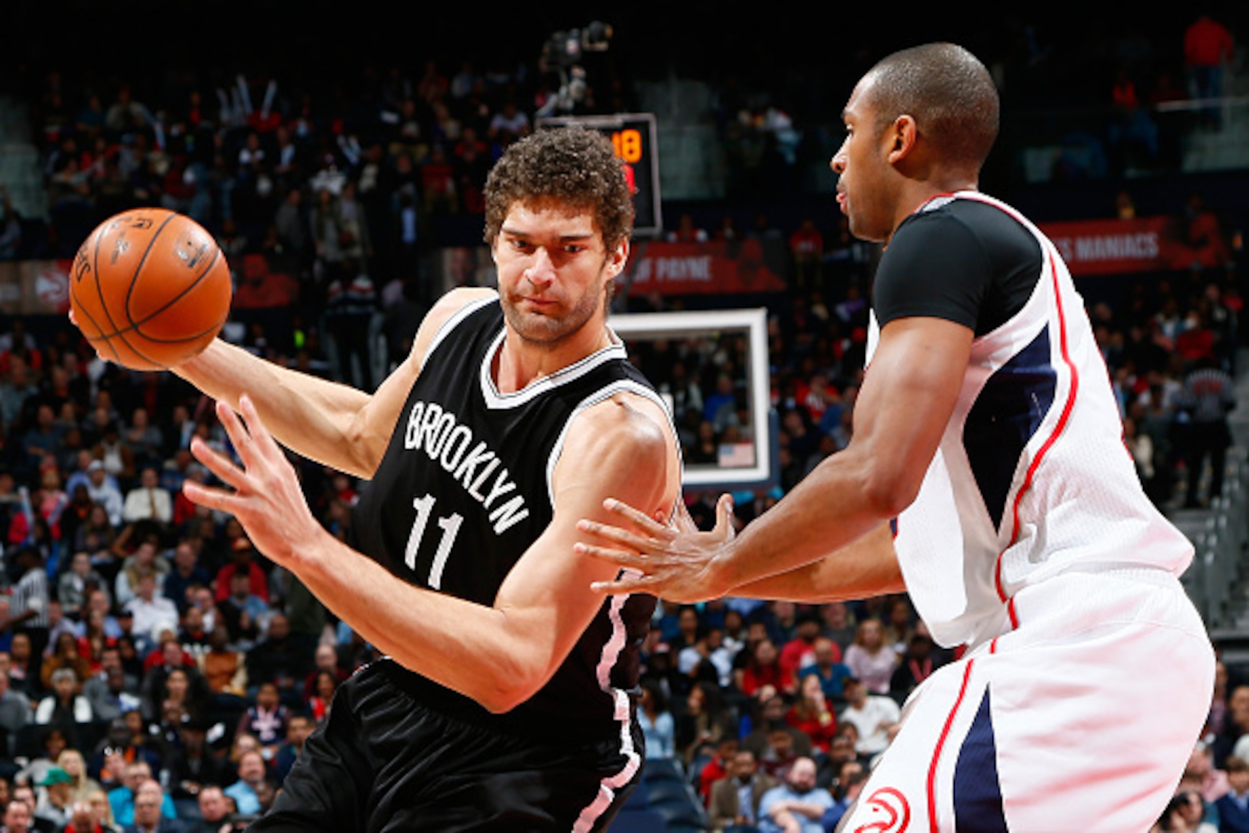 ATLANTA, GA - JANUARY 28:  Al Horford #15 of the Atlanta Hawks defends against Brook Lopez #11 of the Brooklyn Nets at Philips Arena on January 28, 2015 in Atlanta, Georgia.  NOTE TO USER: User expressly acknowledges and agrees that, by downloading and or