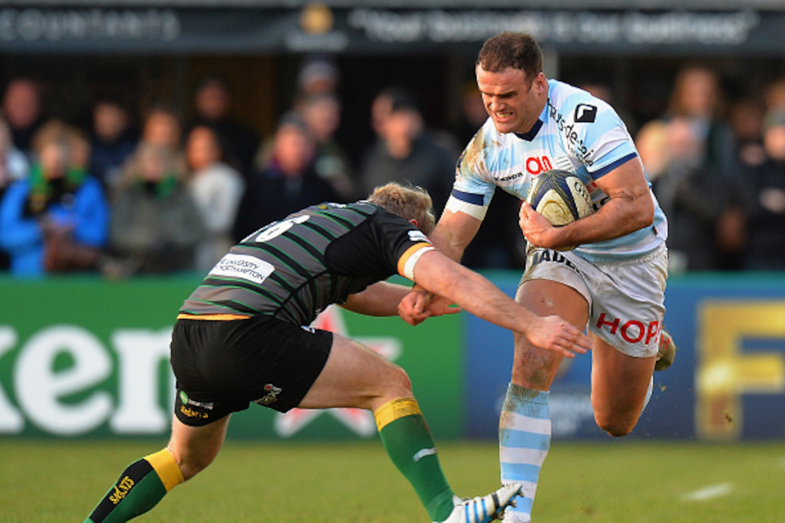 NORTHAMPTON, ENGLAND - JANUARY 24:   Mikey Haywood of Northampton Saints tackles Jamie Roberts of Racing Metro 92 during the European Rugby Champions Cup match between Northampton Saints and Racing Metro 92 at Franklin's Gardens on January 24, 2015 in Nor