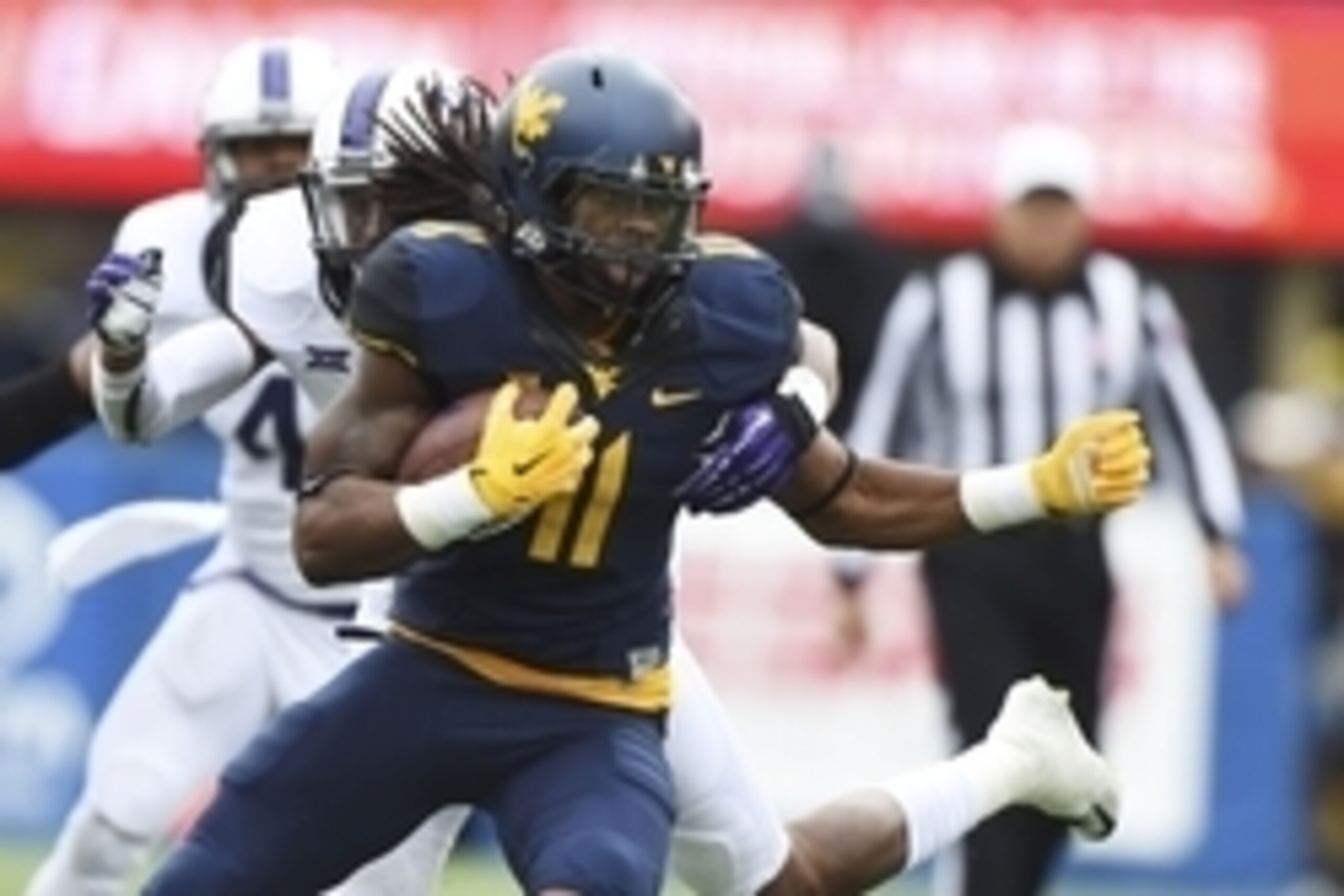 Nov 1, 2014; Morgantown, WV, USA;  West Virginia Mountaineers wide receiver Kevin White (11) runs past TCU Horned Frogs cornerback Ranthony Texada (11) during the first quarter at Milan Puskar Stadium. Mandatory Credit: Tommy Gilligan-USA TODAY Sports