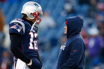 FOXBORO, MA - JANUARY 10:  Tom Brady #12 and head coach Bill Belichick of the New England Patriots talk before the 2014 AFC Divisional Playoffs game against the Baltimore Ravens at Gillette Stadium on January 10, 2015 in Foxboro, Massachusetts.  (Photo by