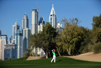 DUBAI, UNITED ARAB EMIRATES - JANUARY 29:  Rory McIlroy of Northern Ireland plays his second shot into the 13th green during the first round of the Omega Dubai Desert Classic on the Majlis Course at the Emirates Golf Club on January 29, 2015 in Dubai, Uni