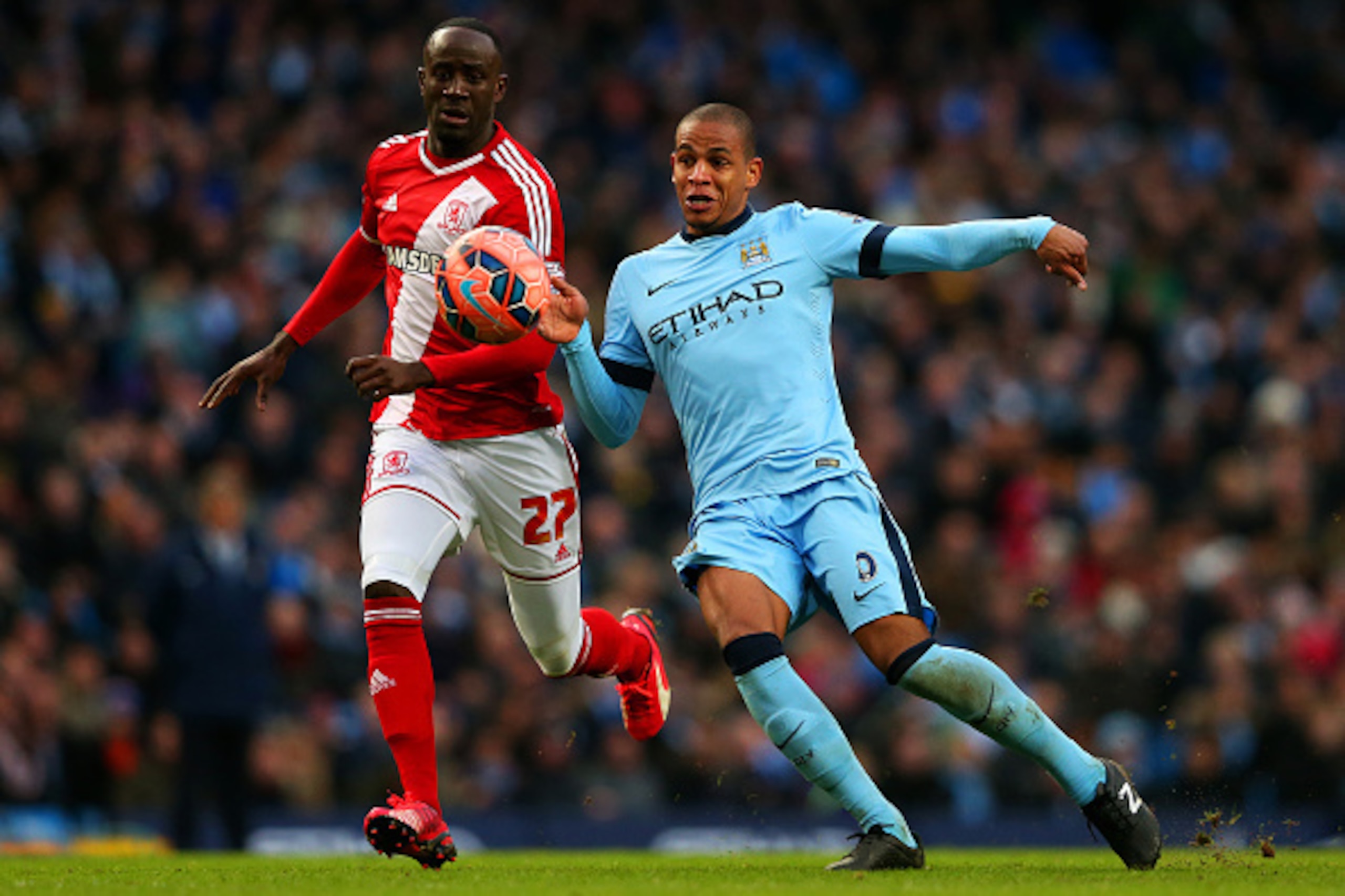 MANCHESTER, ENGLAND - JANUARY 24:  Albert Adomah of Middlesbrough chases Fernando of Manchester City as he underhits a backpass to Wilfredo Caballero of Manchester City leading to the opening goal scored by Patrick Bamford of Middlesbrough during the FA C