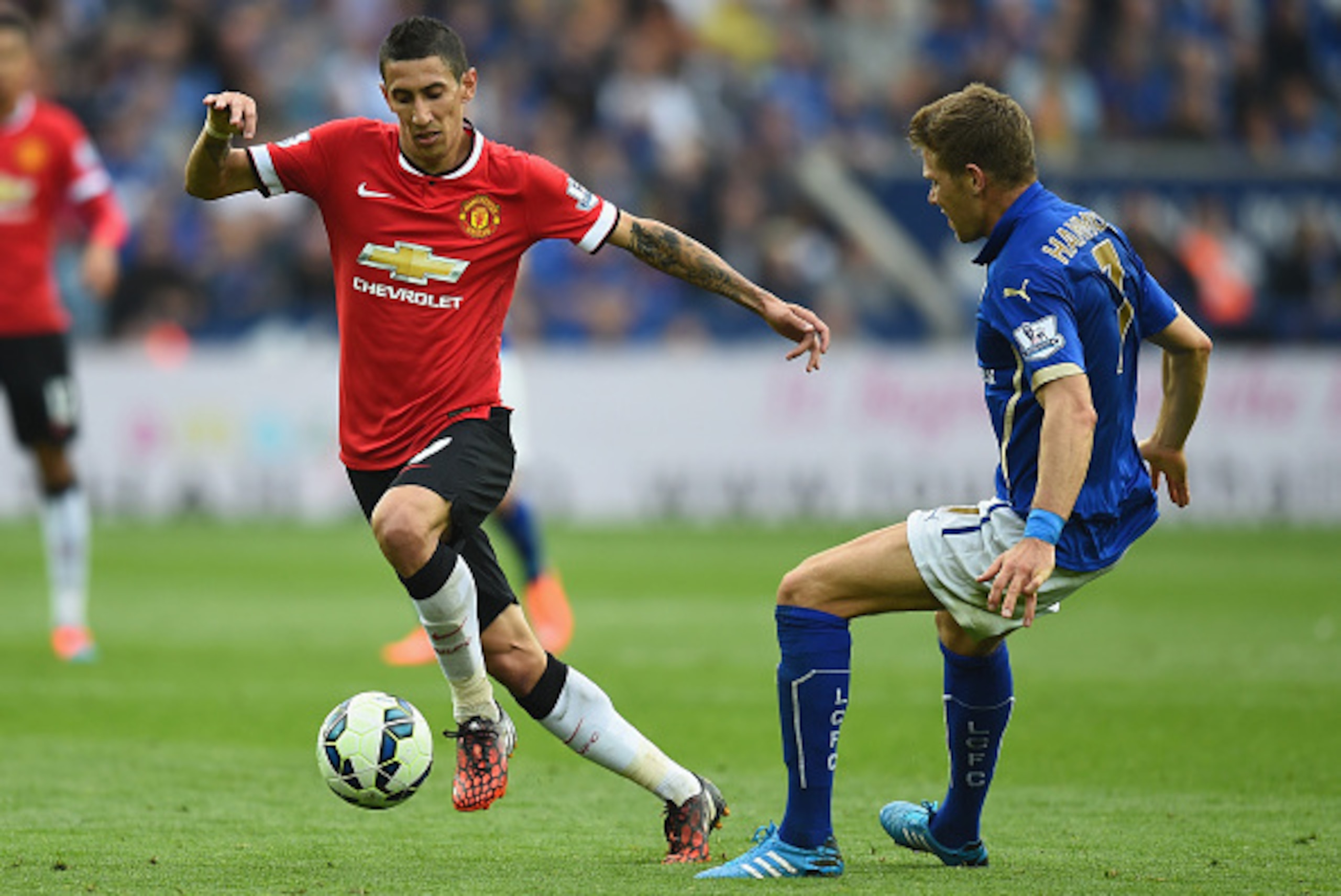 LEICESTER, ENGLAND - SEPTEMBER 21:  Angel Di Maria of Manchester United gets past Dean Hammond of Leicester during the Barclays Premier League match between Leicester City and Manchester United at The King Power Stadium on September 21, 2014 in Leicester,