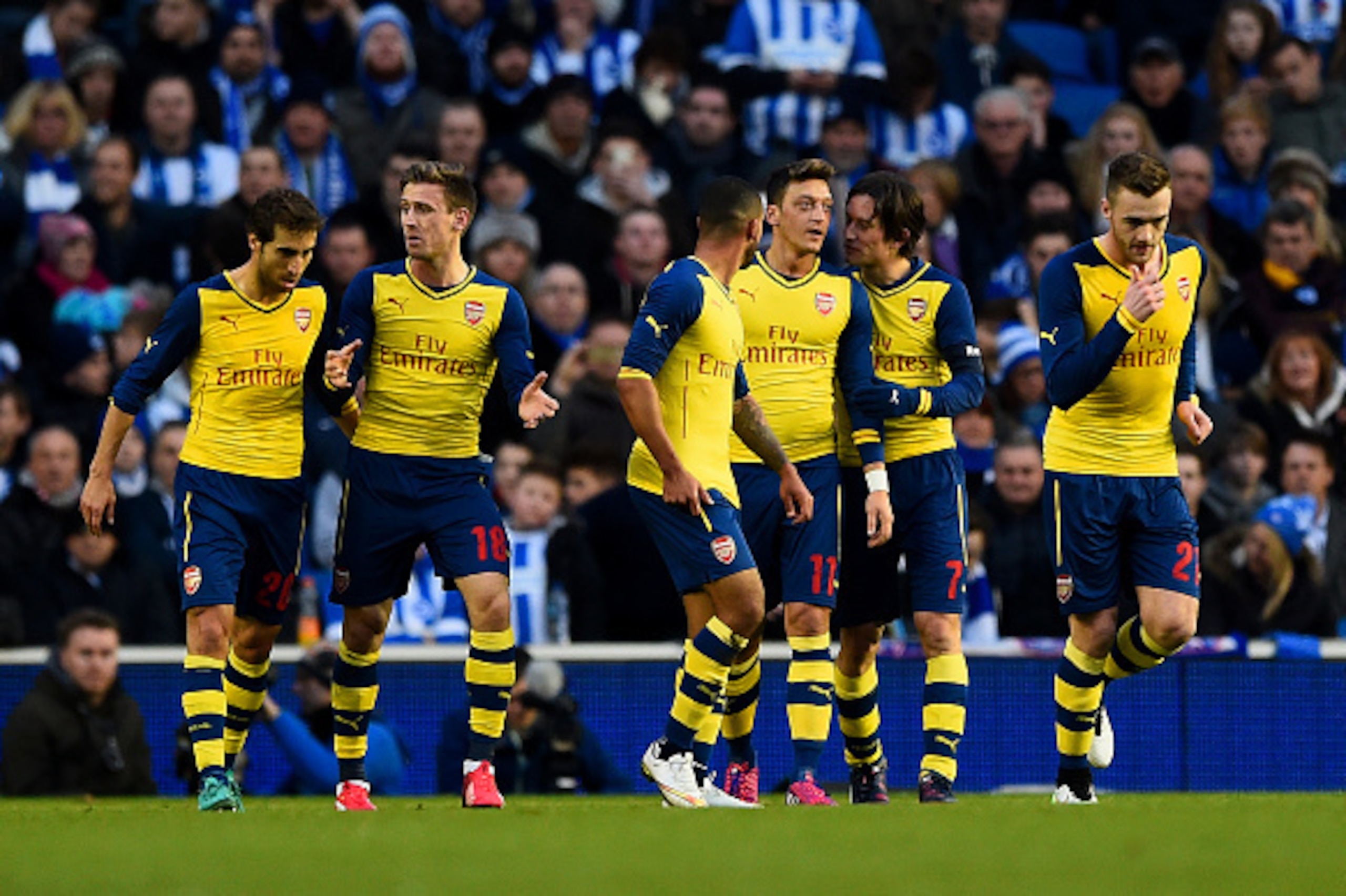 BRIGHTON, ENGLAND - JANUARY 25:  Mesut Oezil of Arsenal celebrates with team-mates after scoring their second goal during the FA Cup Fourth Round match between Brighton & Hove Albion and Arsenal at Amex Stadium on January 25, 2015 in Brighton, England.  (