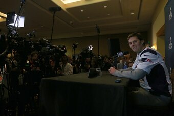 CHANDLER, AZ - JANUARY 28:  Quarterback  Tom Brady #12 of the New England Patriots speaks with the media on January 28, 2015 in Chandler, Arizona.  (Photo by Elsa/Getty Images)