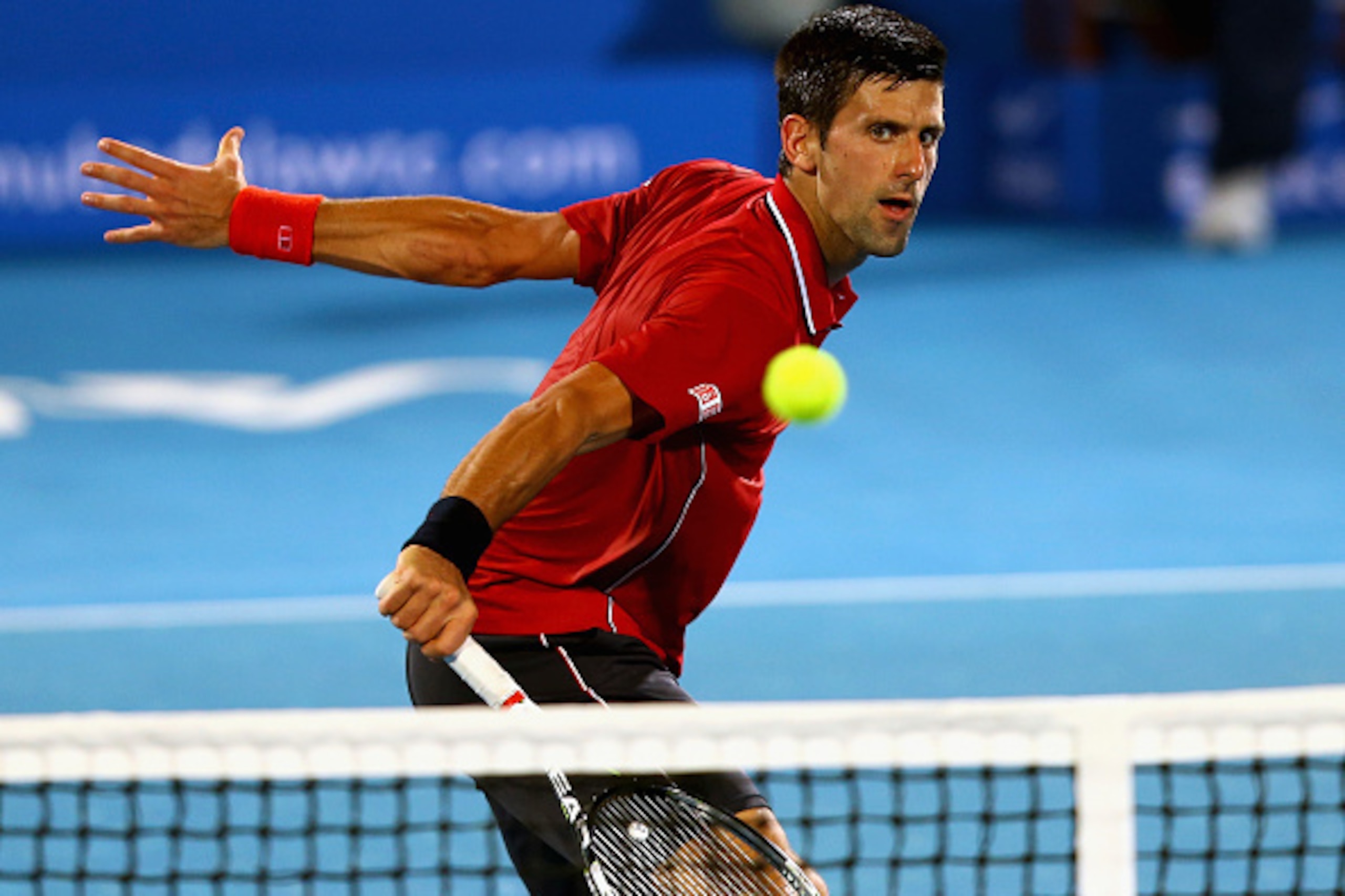 ABU DHABI, UNITED ARAB EMIRATES - JANUARY 02:  Novak Djokovic of Serbia  in action against  Stanislas Wawrinka of Switzerland during the semi final match of the Mubadala World Tennis Championship at Zayed Sport City  on January 2, 2015 in Abu Dhabi, Unite