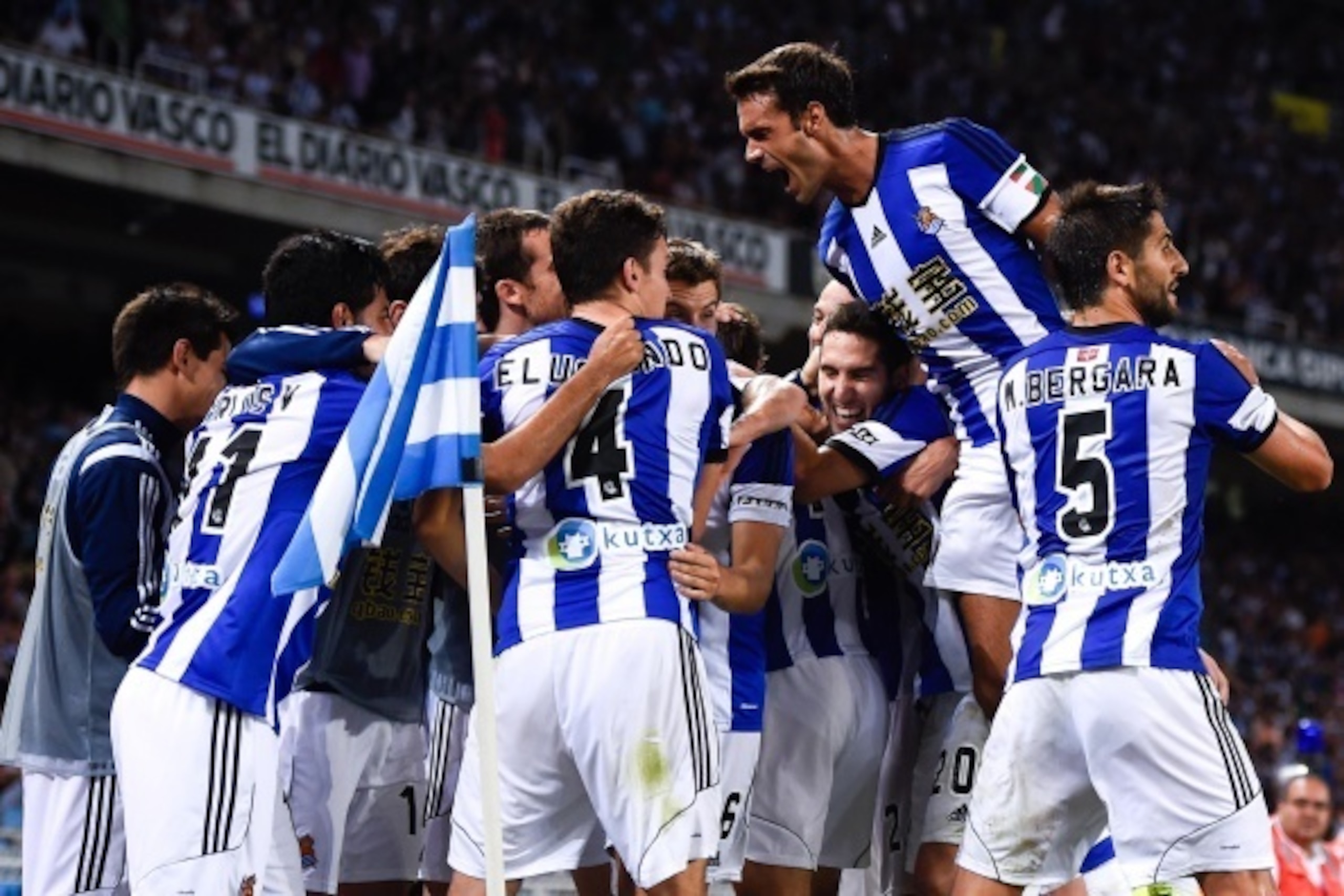 SAN SEBASTIAN, SPAIN - AUGUST 31:  Carlos Vela Garrido (L) of Real Sociedad celebrates with his teammates after scoring his team's fourth goal during the La Liga match between Real Sociedad de Futbol and Real Madrid CF at Estadio Anoeta on August 31, 2014