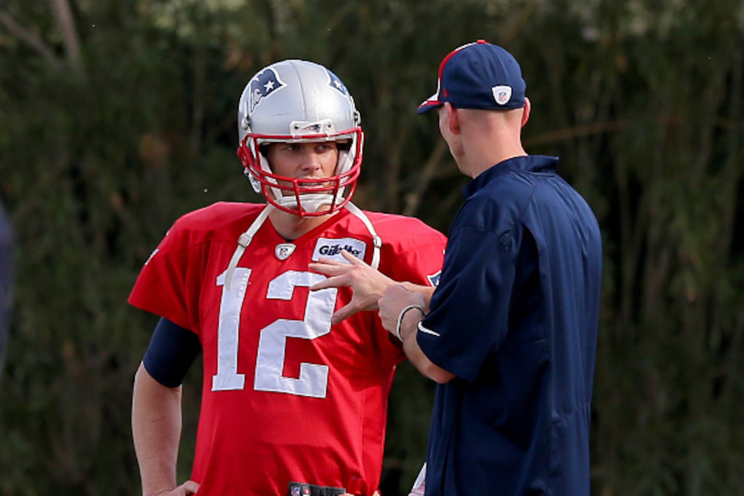 TEMPE, AZ - JANUARY 28:  Tom Brady #12 of the New England Patriots talks with recievers coach Chad O'Shea during the New England Patriots Super Bowl XLIX Practice on January 28, 2015 at the Arizona Cardinals Practice Facility in Tempe, Arizona.  (Photo by