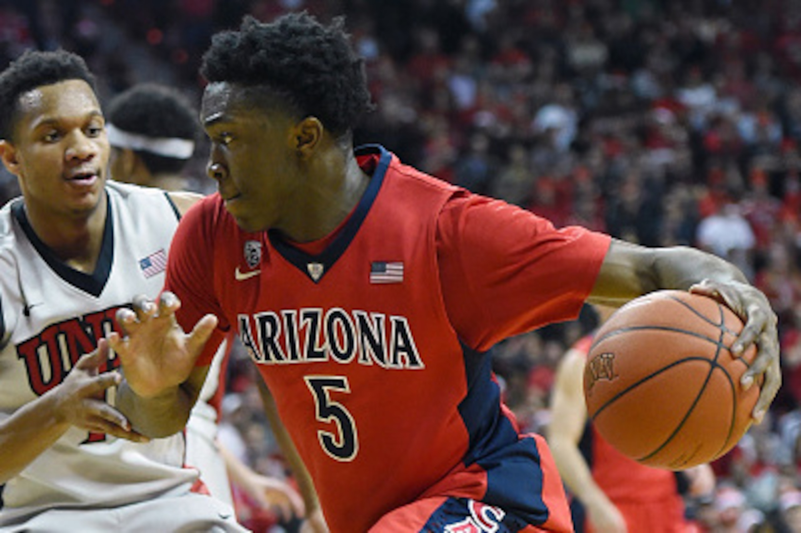 LAS VEGAS, NV - DECEMBER 23:  Stanley Johnson #5 of the Arizona Wildcats drives against Rashad Vaughn #1 of the UNLV Rebels during their game at the Thomas & Mack Center on December 23, 2014 in Las Vegas, Nevada. UNLV won 71-67.  (Photo by Ethan Miller/Ge