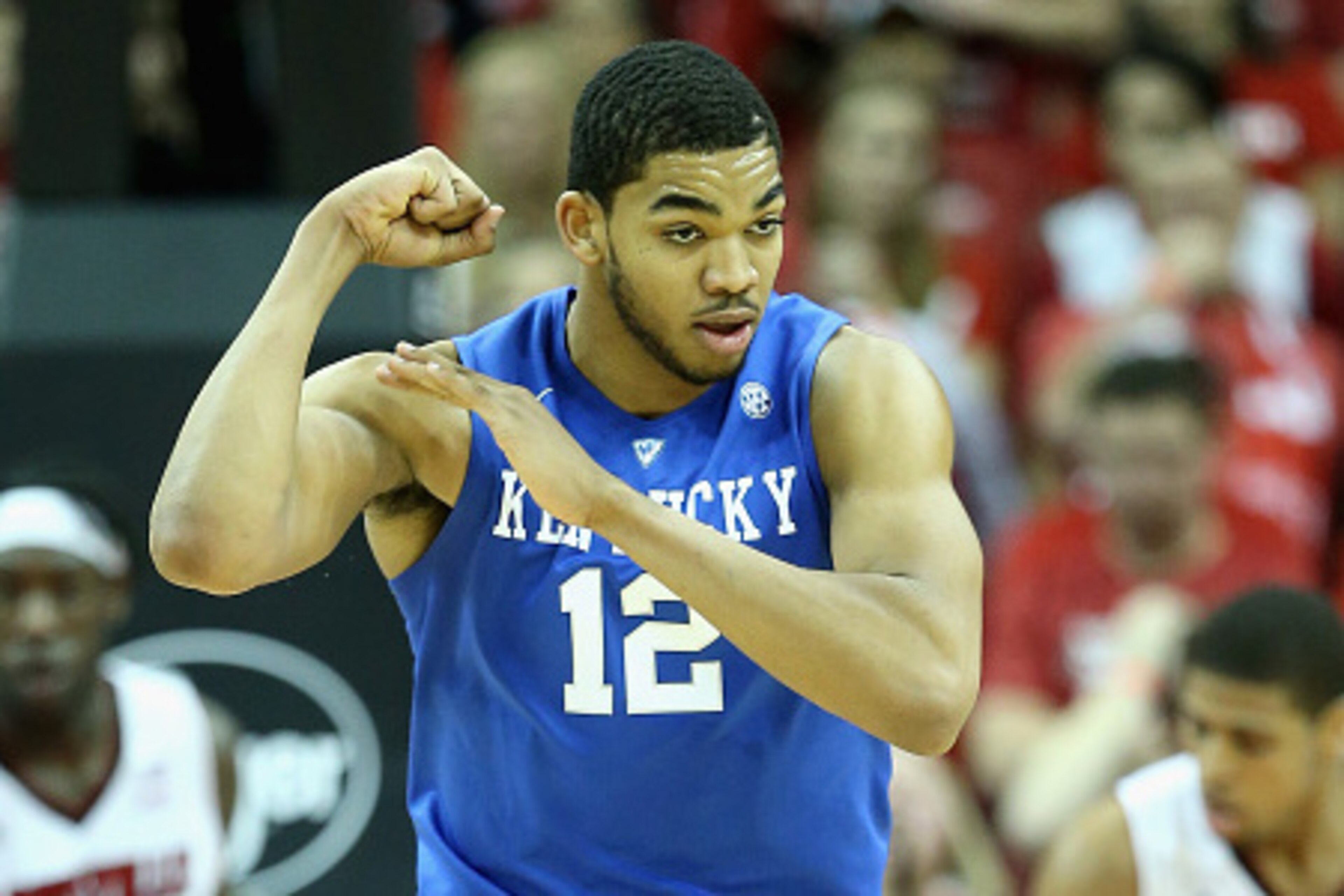 LOUISVILLE, KY - DECEMBER 27: Karl-Anthony Towns #12 of the Kentucky Wildcats celebrates by flexing his muscles during the game against the Louisville Cardinals at KFC YUM! Center on December 27, 2014 in Louisville, Kentucky. Kentucky won 58-50. (Phot LOUISVILLE, KY - DECEMBER 27: Karl-Anthony Towns #12 of the Kentucky Wildcats celebrates by flexing his muscles during the game against the Louisville Cardinals at KFC YUM! Center on December 27, 2014 in Louisville, Kentucky. Kentucky won 58-50. (Phot