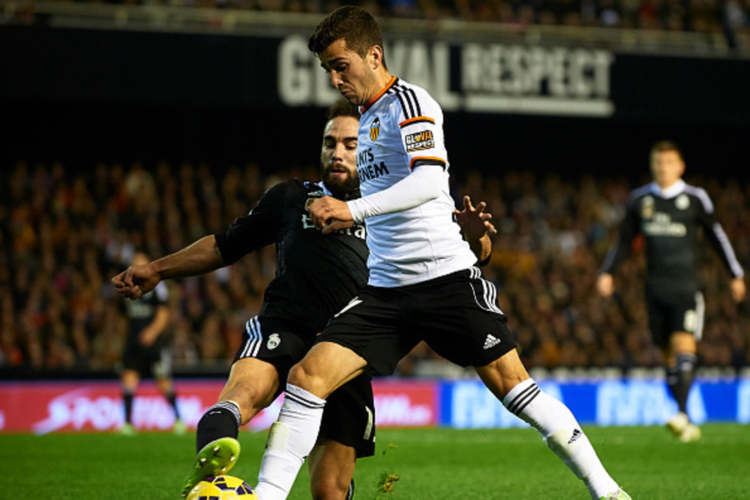VALENCIA, SPAIN - JANUARY 04:  Jose Gaya (R) of Valencia is tackled by Carvajal of Real Madrid during the La Liga match between Valencia CF and Real Madrid CF at Estadi de Mestalla on January 4, 2015 in Valencia, Spain.  (Photo by Manuel Queimadelos Alons