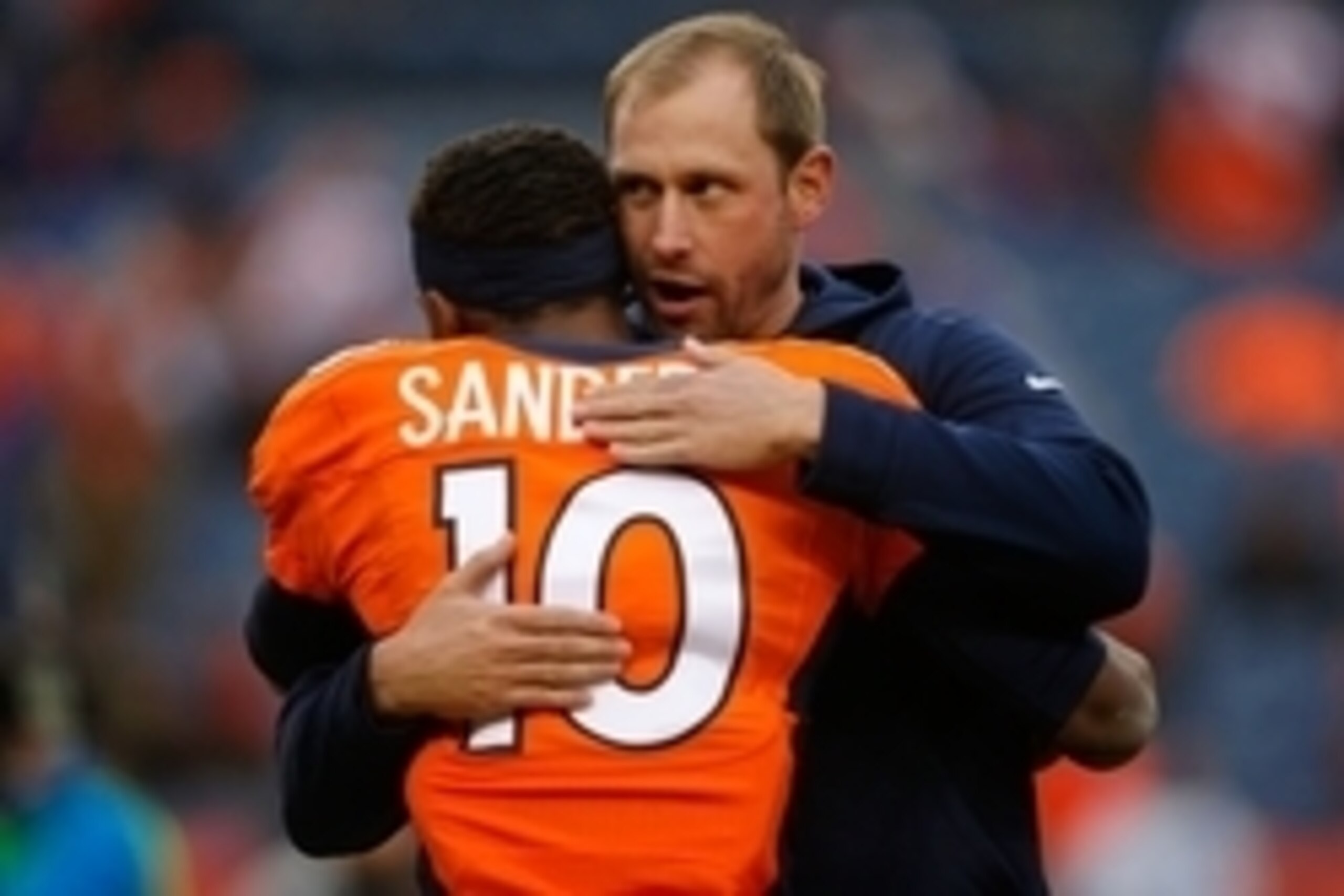 Jan 11, 2015; Denver, CO, USA; (EDITORS NOTE: Caption Correction) Denver Broncos offensive coordinator Adam Gase hugs wide receiver Emmanuel Sanders (10) before the game against the Indianapolis Colts in the 2014 AFC Divisional playoff football game at Sp