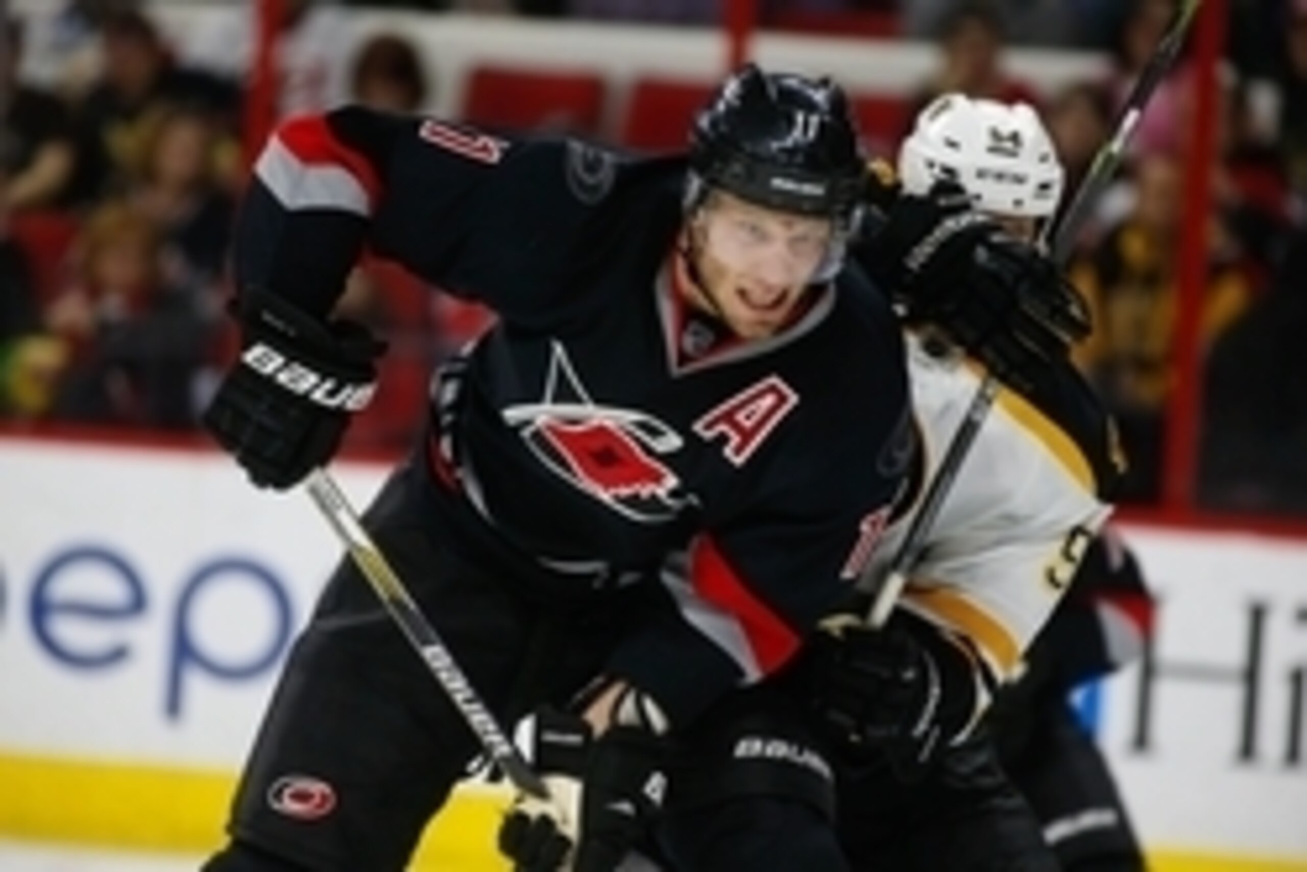 Jan 4, 2015; Raleigh, NC, USA; Carolina Hurricanes forward Jordan Staal (11) fights for position against the Boston Bruins at PNC Arena. The Carolina Hurricanes defeated the Boston Bruins 2-1 in the shoot out. Mandatory Credit: James Guillory-USA TODAY Sp