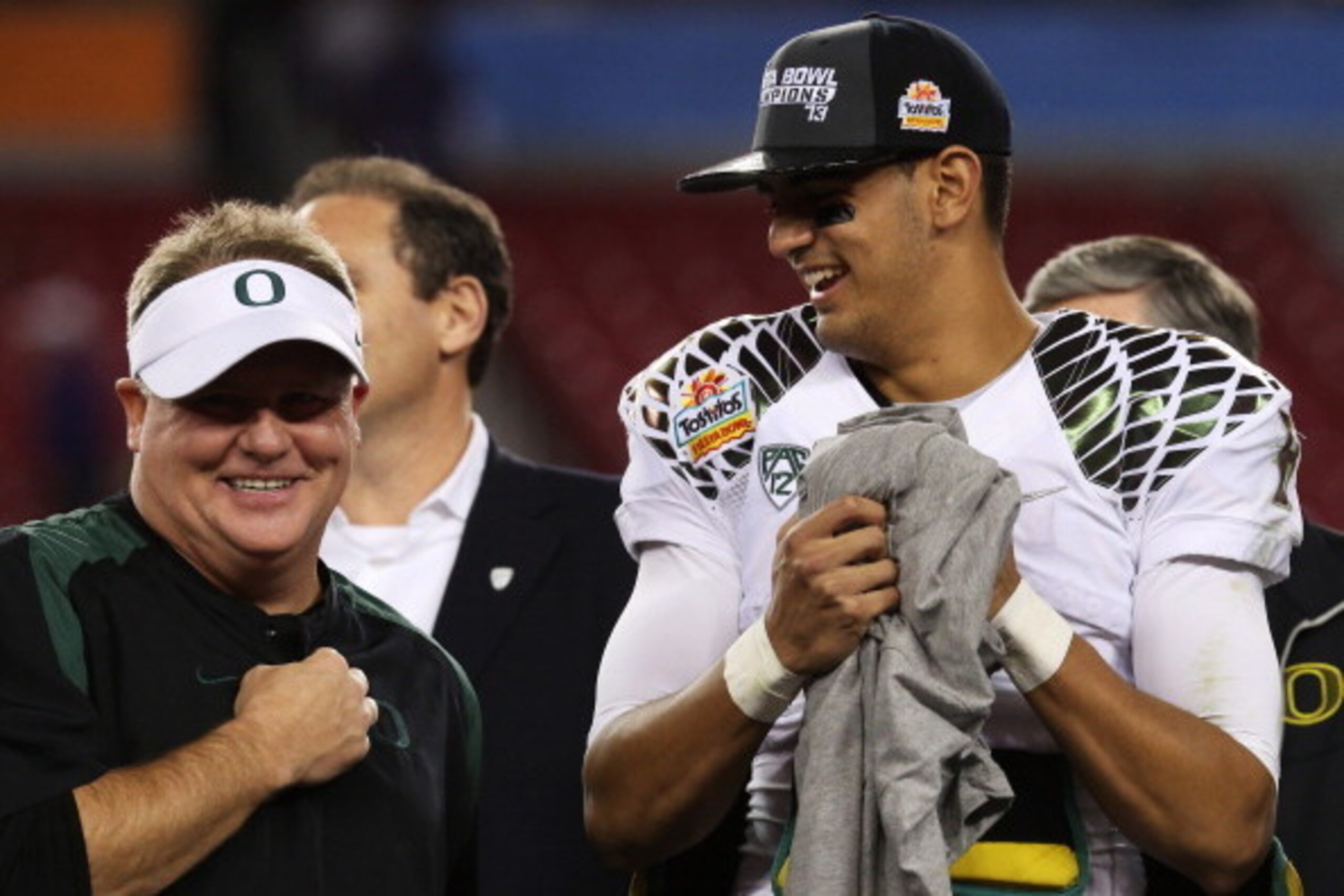 GLENDALE, AZ - JANUARY 03:  Head coach Chip Kelly celebrates with Marcus Mariota #8 of the Oregon Ducks after their 35 to 17 win over the Kansas State Wildcats in the Tostitos Fiesta Bowl at University of Phoenix Stadium on January 3, 2013 in Glendale, Ar