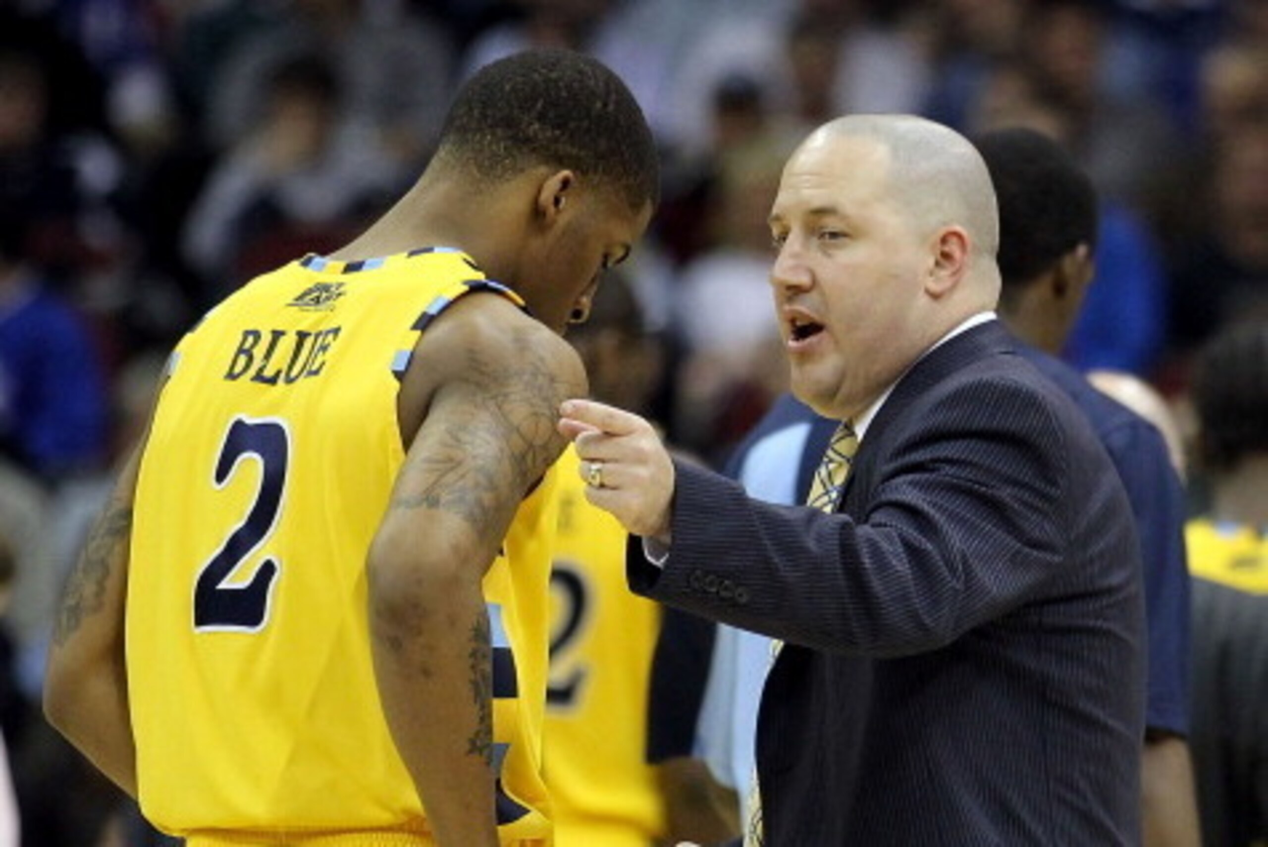NEWARK, NJ - MARCH 25:  Head coach Buzz Williams (R) of the Marquette Golden Eagles talks with Vander Blue #2 of the Marquette Golden Eagles after a play against the North Carolina Tar Heels during the first half the east regional semifinal of the 2011 NC