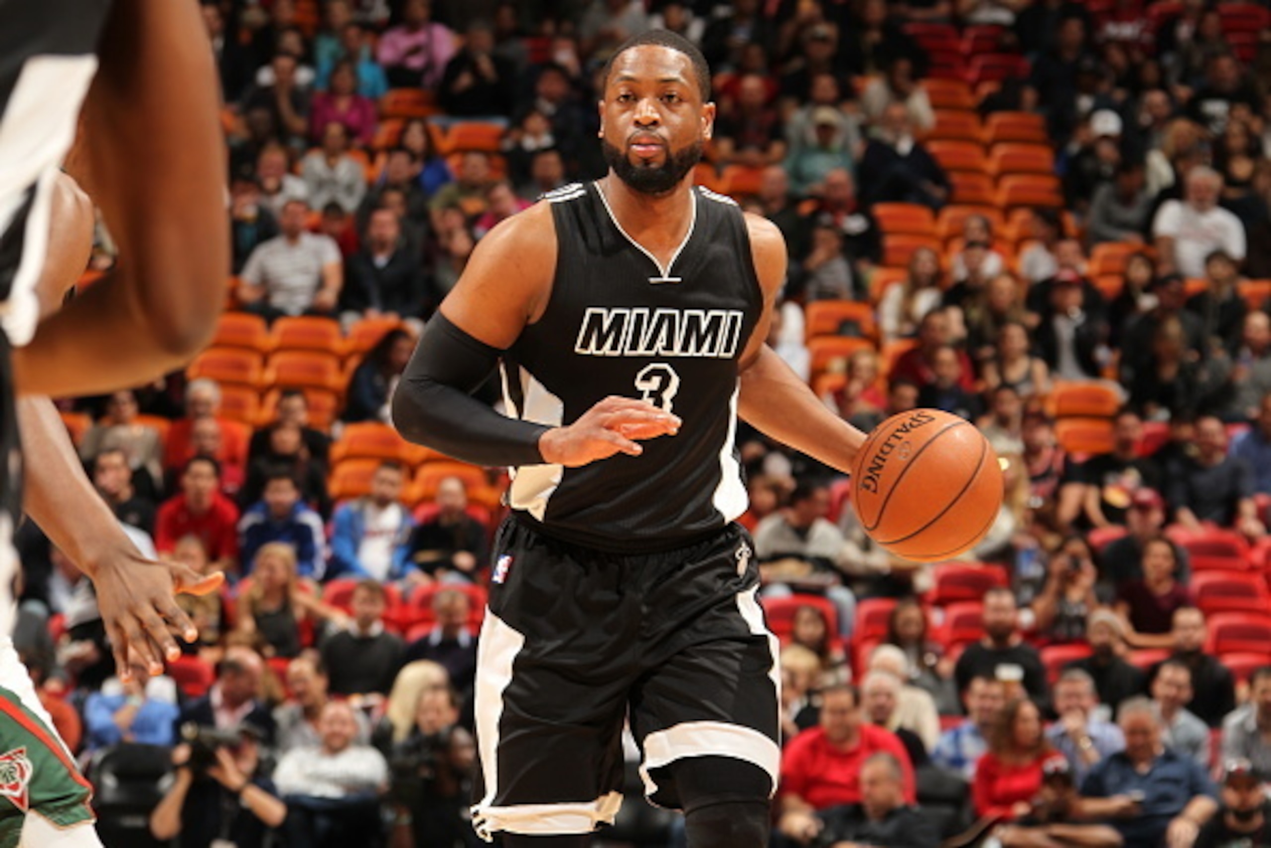 MIAMI, FL - JANUARY 27:  Dwyane Wade #3 of the Miami Heat brings the ball up court against the Milwaukee Bucks on January 27, 2015  at American Airlines Arena in Miami, Florida.  NOTE TO USER: User expressly acknowledges and agrees that, by downloading an