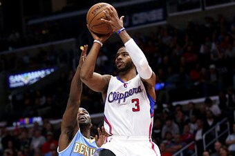 LOS ANGELES, CA - JANUARY 26: Chris Paul #3 of the Los Angeles Clippers shoots over Ty Lawson #3 of the Denver Nuggets at Staples Center on January 26, 2015 in Los Angeles, California.  The Clippers won 102-98.  NOTE TO USER: User expressly acknowledges a