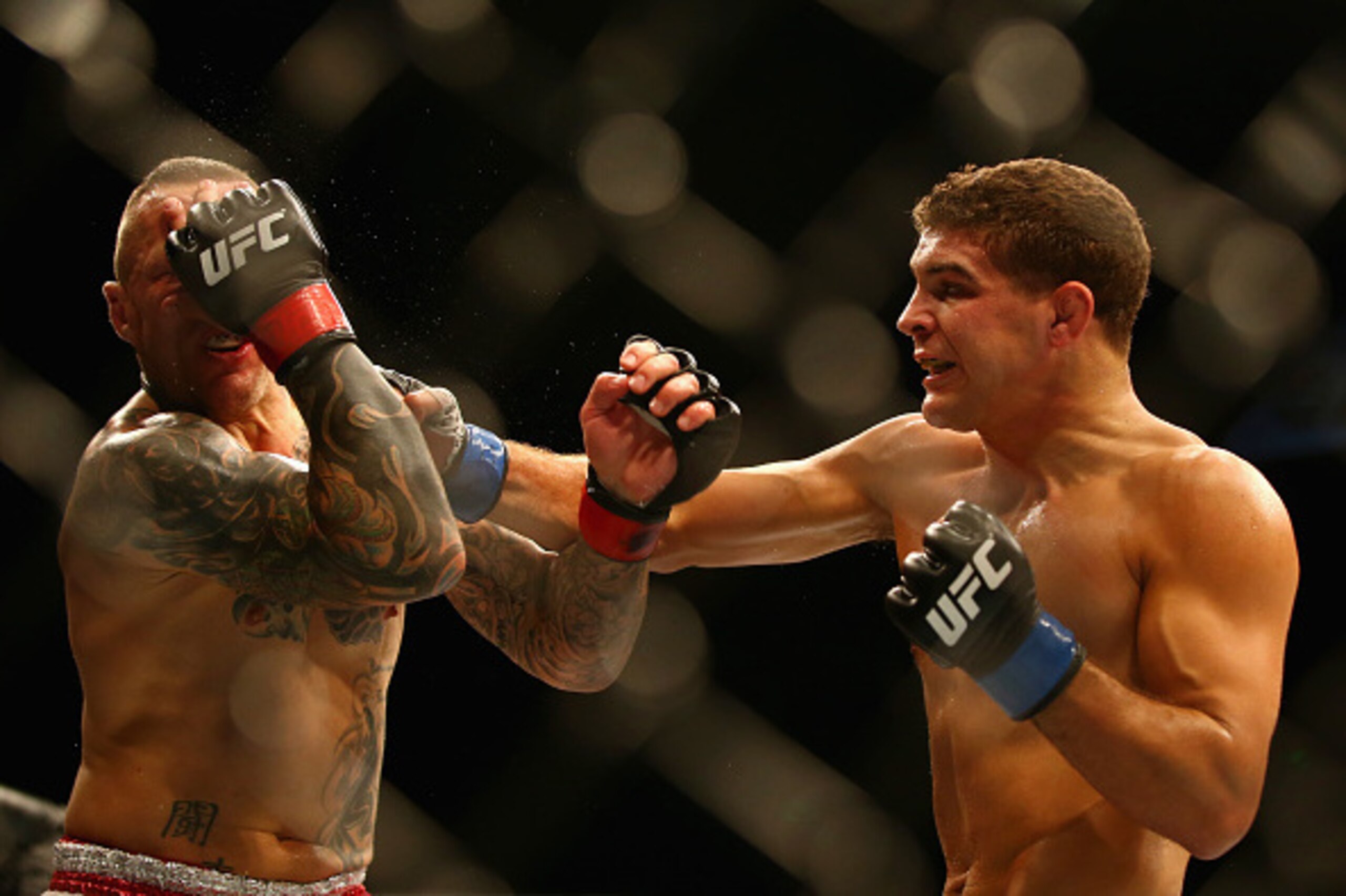 SYDNEY, AUSTRALIA - NOVEMBER 08:  Ross Pearson of England is hit with a right hand by Al Iaquinta of the USA in their lightweight fight during the UFC Fight Night 55 event at Allphones Arena on November 8, 2014 in Sydney, Australia.  (Photo by Mark Kolbe/