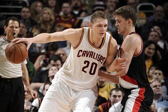 CLEVELAND, OH - JANUARY 28:  Timofey Mozgov #20 of the Cleveland Cavaliers handles the ball against Meyers Leonard #11 of the Portland Trail Blazers on January 28, 2015 at Quicken Loans Arena in Cleveland, Ohio. NOTE TO USER: User expressly acknowledges a