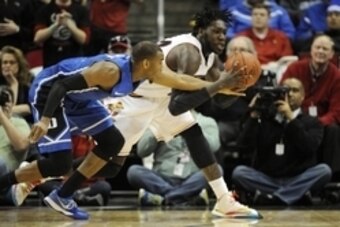 Jan 17, 2015; Louisville, KY, USA; Duke Blue Devils guard Rasheed Sulaimon (14) battles Louisville Cardinals forward Montrezl Harrell (24) for the ball during the first half at KFC Yum! Center. Mandatory Credit: Jamie Rhodes-USA TODAY Sports
