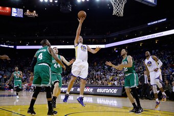 OAKLAND, CA - JANUARY 25:  David Lee #10 of the Golden State Warriors goes up for a shot against the Boston Celtics at ORACLE Arena on January 25, 2015 in Oakland, California. NOTE TO USER: User expressly acknowledges and agrees that, by downloading and o
