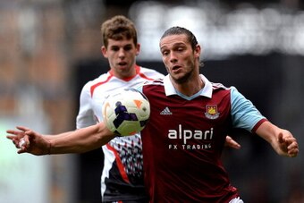 LONDON, ENGLAND - APRIL 06:  Andy Carroll of West Ham controls the ball as Jon Flanagan of Liverpool closes during the Barclays Premier League match between West Ham United and Liverpool at Boleyn Ground on April 6, 2014 in London, England.  (Photo by Mik