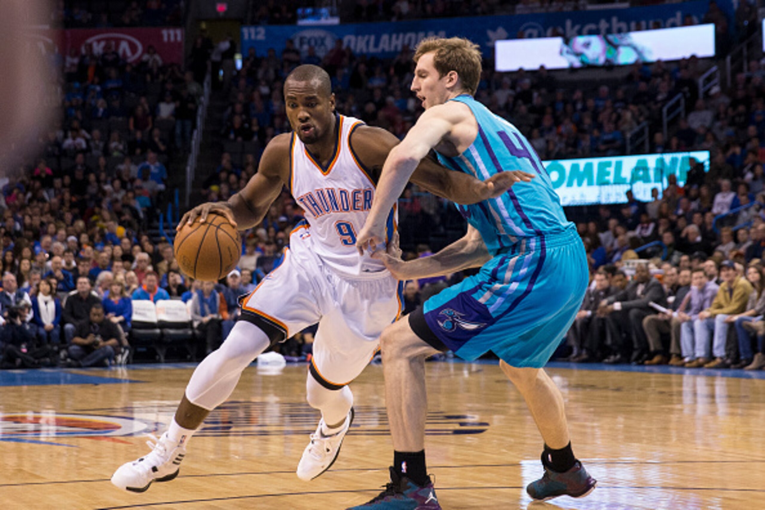 OKLAHOMA CITY, OK - DECEMBER 26: Serge Ibaka #9 of the Oklahoma City Thunder drives against Cody Zeller #40 of the Charlotte Hornets at the Chesapeake Energy Arena  on December 26, 2014 in Oklahoma City, Oklahoma. NOTE TO USER:  User expressly acknowledge