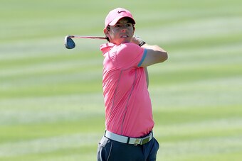 DUBAI, UNITED ARAB EMIRATES - JANUARY 30:  Rory McIlroy of Northern Ireland plays his second shot at the par 4, first hole during the second round of the 2015 Omega Dubai Desert Classic on the Majlis Course at the Emirates Golf Club on January 30, 2015 in