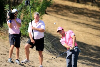DUBAI, UNITED ARAB EMIRATES - JANUARY 30:  Rory McIlroy of Northern Ireland plays his third shot at the par 5, third hole during the second round of the 2015 Omega Dubai Desert Classic on the Majlis Course at the Emirates Golf Club on January 30, 2015 in 