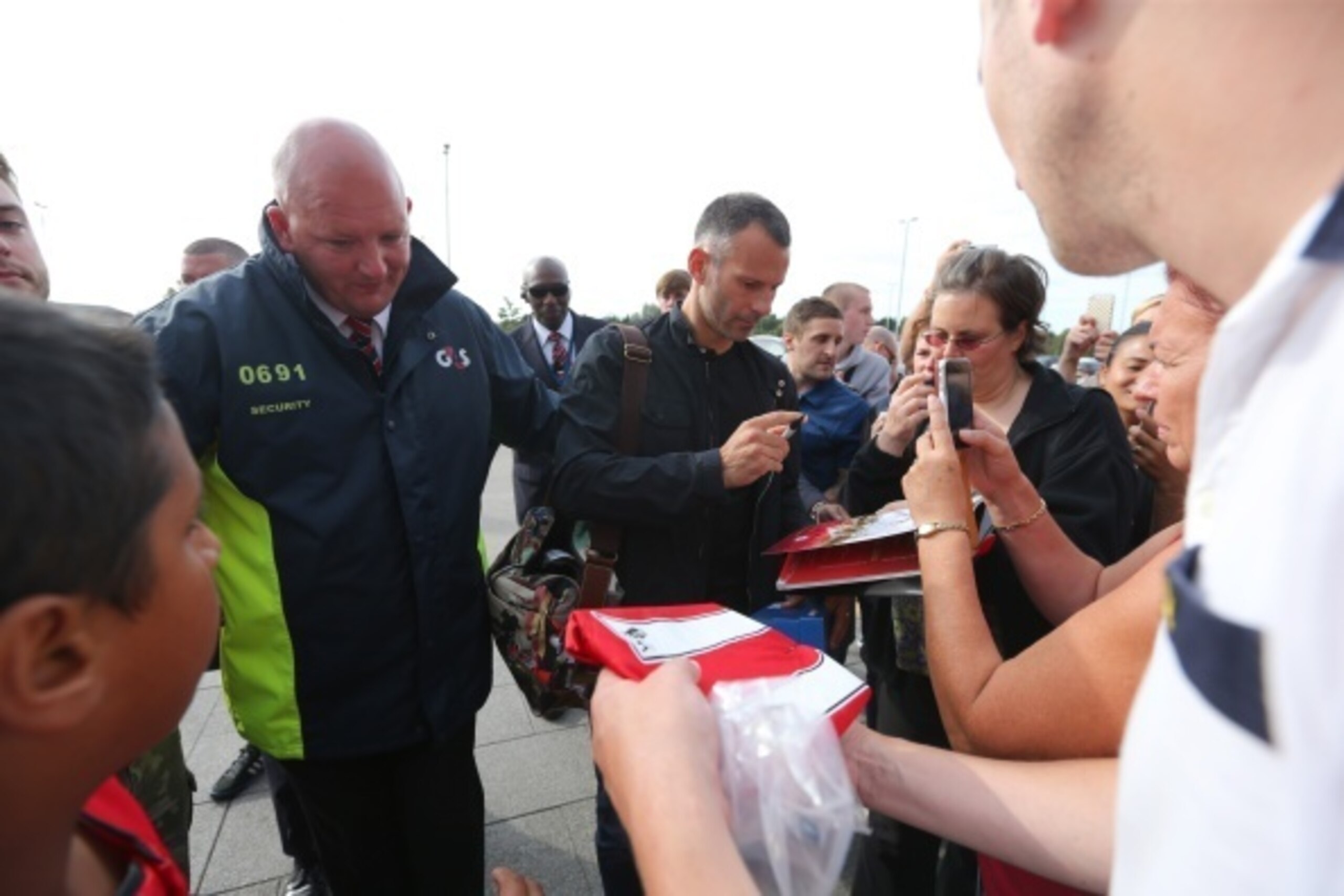 SALFORD, ENGLAND - AUGUST 07: Ryan Giggs is greeted by fans as he arrives before the match between Salford City and the Class of '92 XI at AJ Bell Stadium on August 7, 2014 in Salford, England.  (Photo by Dave Thompson/Getty Images)