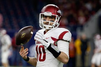 HOUSTON, TX - DECEMBER 29:  Brandon Allen #10 of the Arkansas Razorbacks works with his team on the field before the start of their game against the Texas Longhorns at the AdvoCare V100 Texas Bowl at NRG Stadium on December 29, 2014 in Houston, Texas.  (P