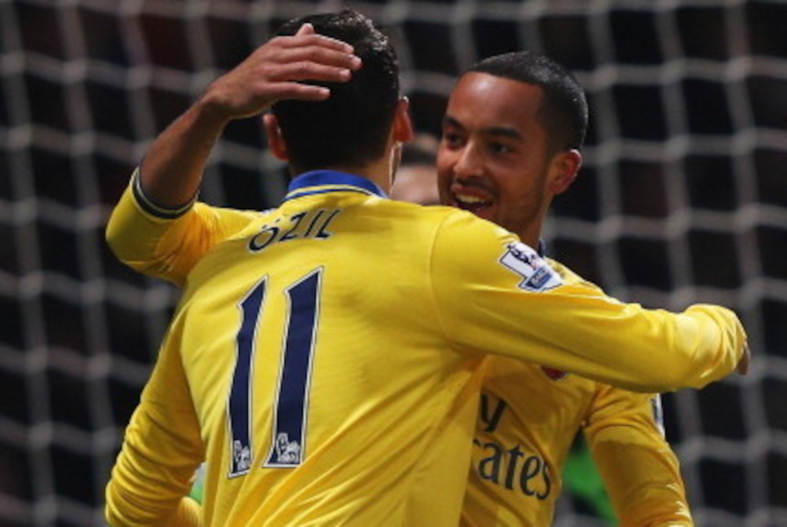 LONDON, ENGLAND - DECEMBER 26:  Theo Walcott of Arsenal (R) celebrates with Mesut Oezil (11) as he scores their first goal during the Barclays Premier League match between West Ham United and Arsenal at Boleyn Ground on December 26, 2013 in London, Englan