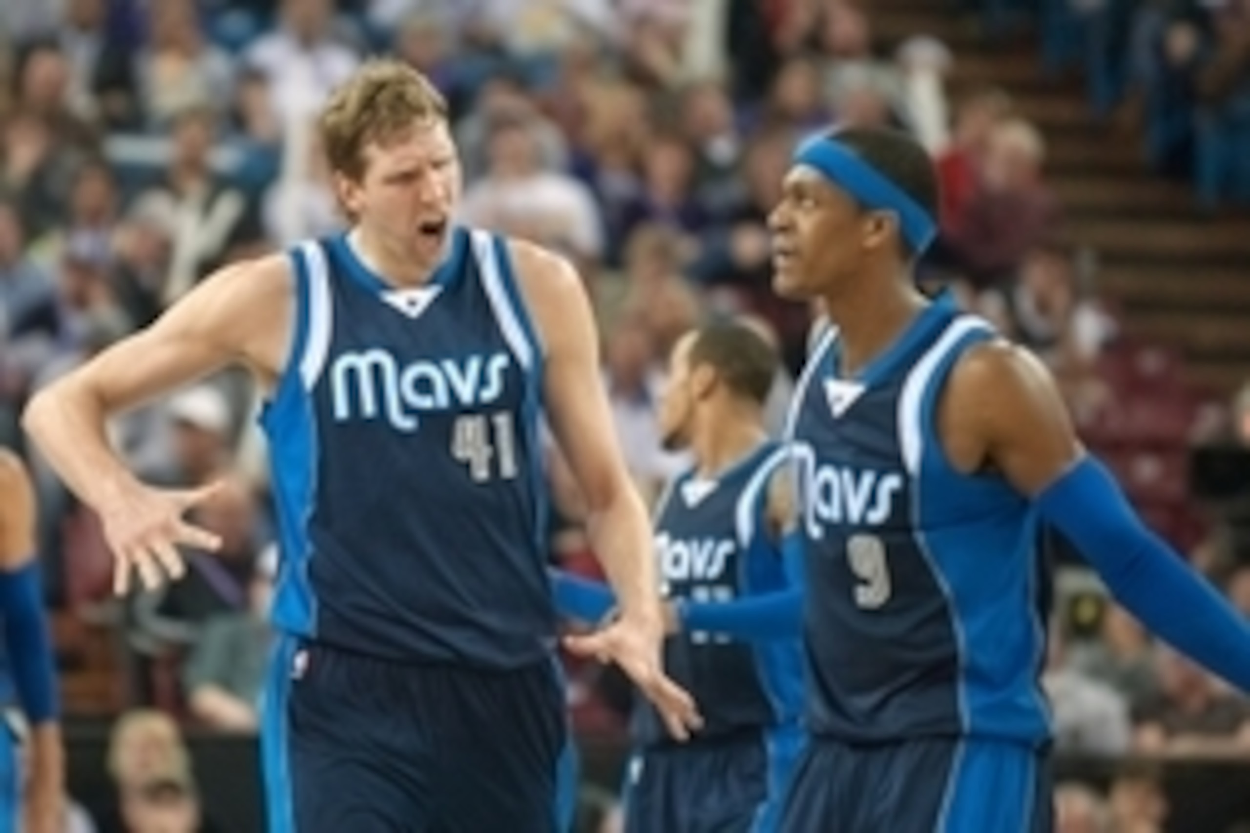 Jan 13, 2015; Sacramento, CA, USA; Dallas Mavericks forward Dirk Nowitzki (41) and guard Rajon Rondo (9) celebrate after scoring against the Sacramento Kings during the third quarter at Sleep Train Arena. The Dallas Mavericks defeated the Sacramento Kings