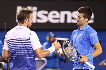 MELBOURNE, AUSTRALIA - JANUARY 30:  Novak Djokovic of Serbia and Stanislas Wawrinka of Switzerland hug at the net after Djokovic won their semifinal match during day 12 of the 2015 Australian Open at Melbourne Park on January 30, 2015 in Melbourne, Austra