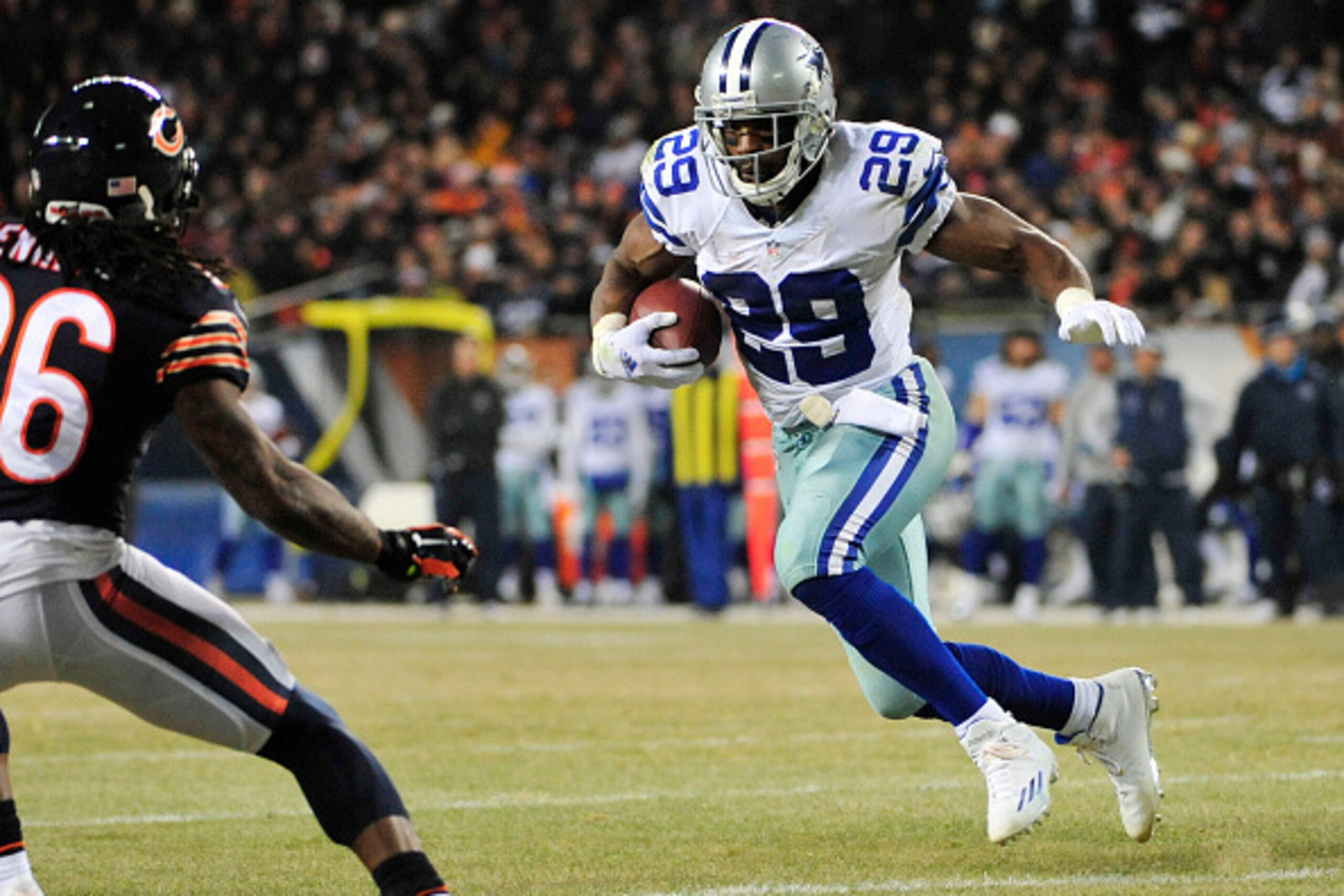 CHICAGO, IL - DECEMBER 4: DeMarco Murray #29 of the Dallas Cowboys runs the ball on Tim Jennings #26 of the Chicago Bears during the third quarter a game at Soldier Field on December 4, 2014 in Chicago, Illinois. (Photo by David Banks/Getty Images)