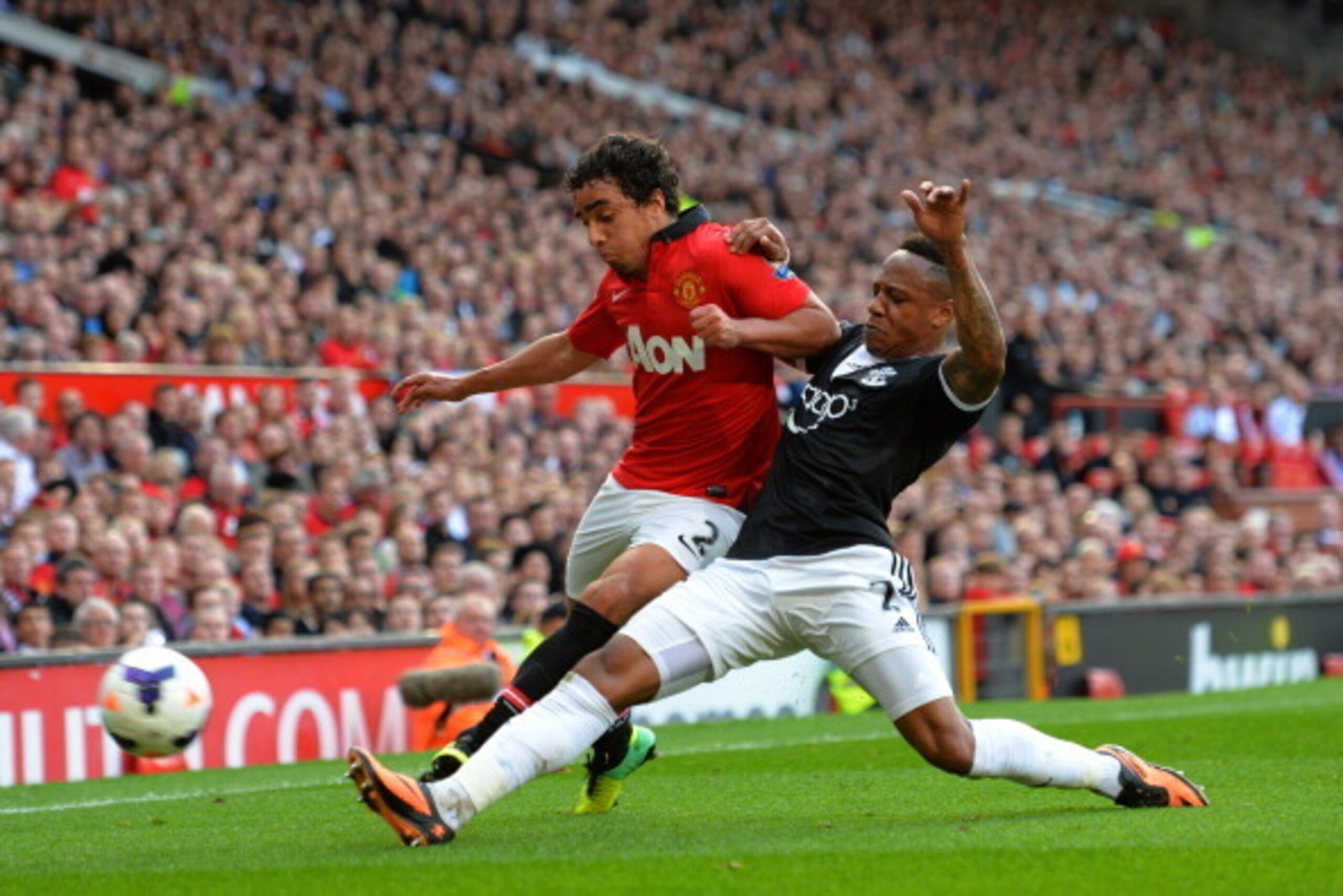 MANCHESTER, ENGLAND - OCTOBER 19: Rafael of Manchester United is tackled by Nathaniel Clyne of Southampton during the Barclays Premier League match between Manchester United and Southampton at Old Trafford on October 19, 2013 in Manchester, England. (Ph MANCHESTER, ENGLAND - OCTOBER 19: Rafael of Manchester United is tackled by Nathaniel Clyne of Southampton during the Barclays Premier League match between Manchester United and Southampton at Old Trafford on October 19, 2013 in Manchester, England. (Ph