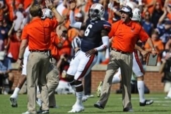 Aug 30, 2014; Auburn, AL, USA; Auburn Tigers offensive coordinator Rhett Lashlee (left) high-fives quarterback Jeremy Johnson (6) after a touchdown  as head coach Gus Malzahn celebrates in the background against the Arkansas Razorbacks at Jordan Hare Stad