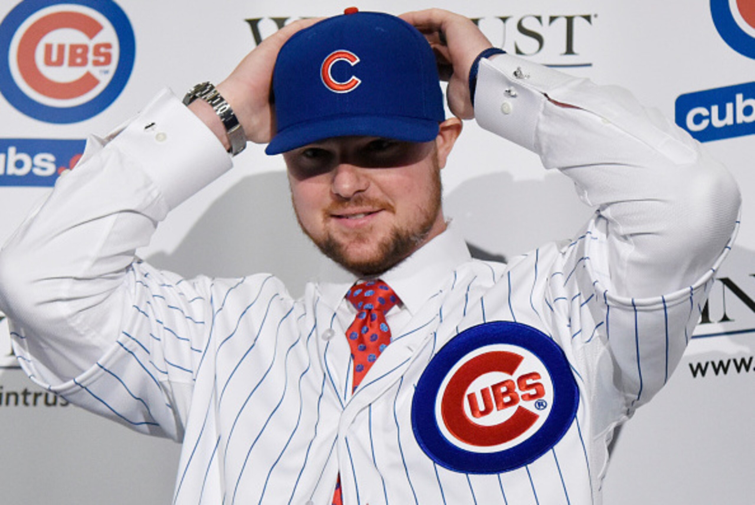 CHICAGO, IL - DECEMBER 15:  Pitcher Jon Lester puts on a Cubs hat during an introduction press conference by the Chicago Cubs on December 15, 2014  in Chicago, Illinois. (Photo by David Banks/Getty Images)
