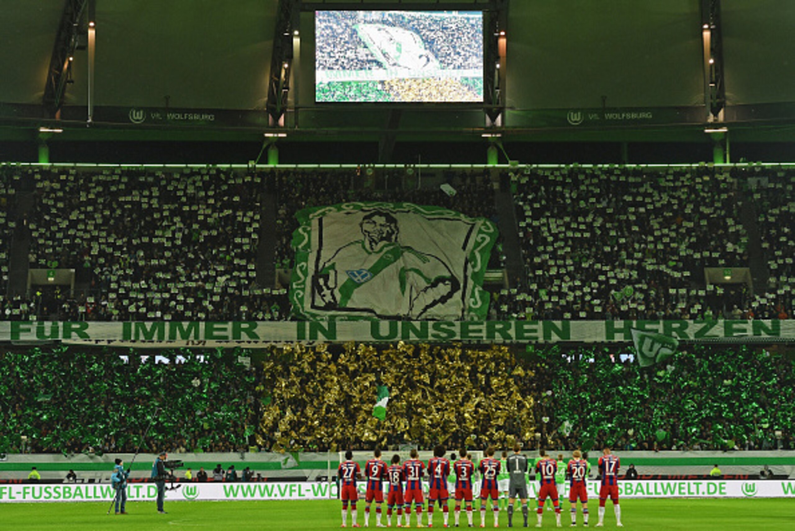 WOLFSBURG, GERMANY - JANUARY 30: Fans and players remember former Wolfsburg player Junior Malanda, recently died in a car crash, prior to the Bundesliga match between VfL Wolfsburg and FC Bayern Muenchen at Volkswagen Arena on January 30, 2015 in Wolfsbu WOLFSBURG, GERMANY - JANUARY 30: Fans and players remember former Wolfsburg player Junior Malanda, recently died in a car crash, prior to the Bundesliga match between VfL Wolfsburg and FC Bayern Muenchen at Volkswagen Arena on January 30, 2015 in Wolfsbu