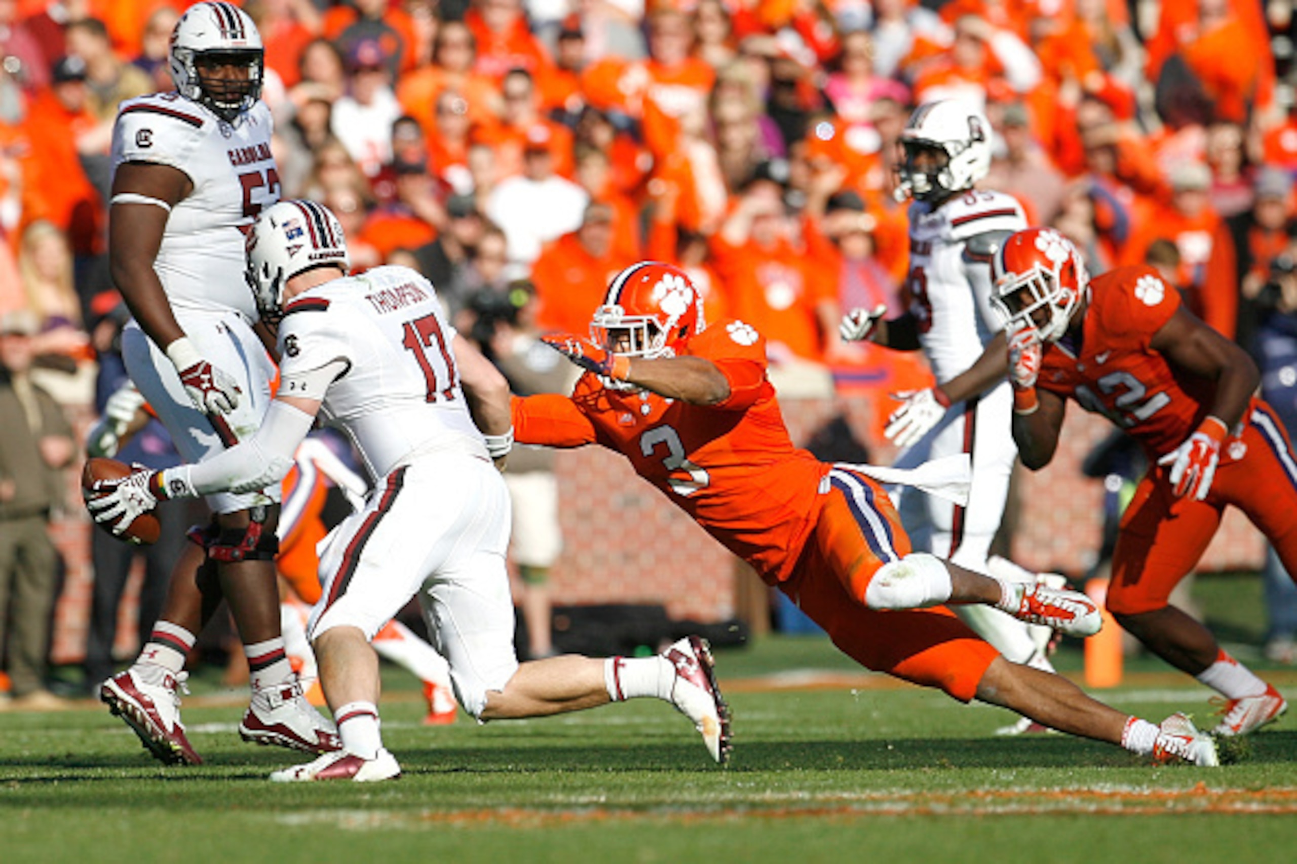 CLEMSON, SC - NOVEMBER 29: Dylan Thompson #17 of the South Carolina Gamecocks scrambles away from Vic Beasley #3 of the Clemson Tigers during their game at Memorial Stadium on November 29, 2014 in Clemson, South Carolina. (Photo by Tyler Smith/Getty Image