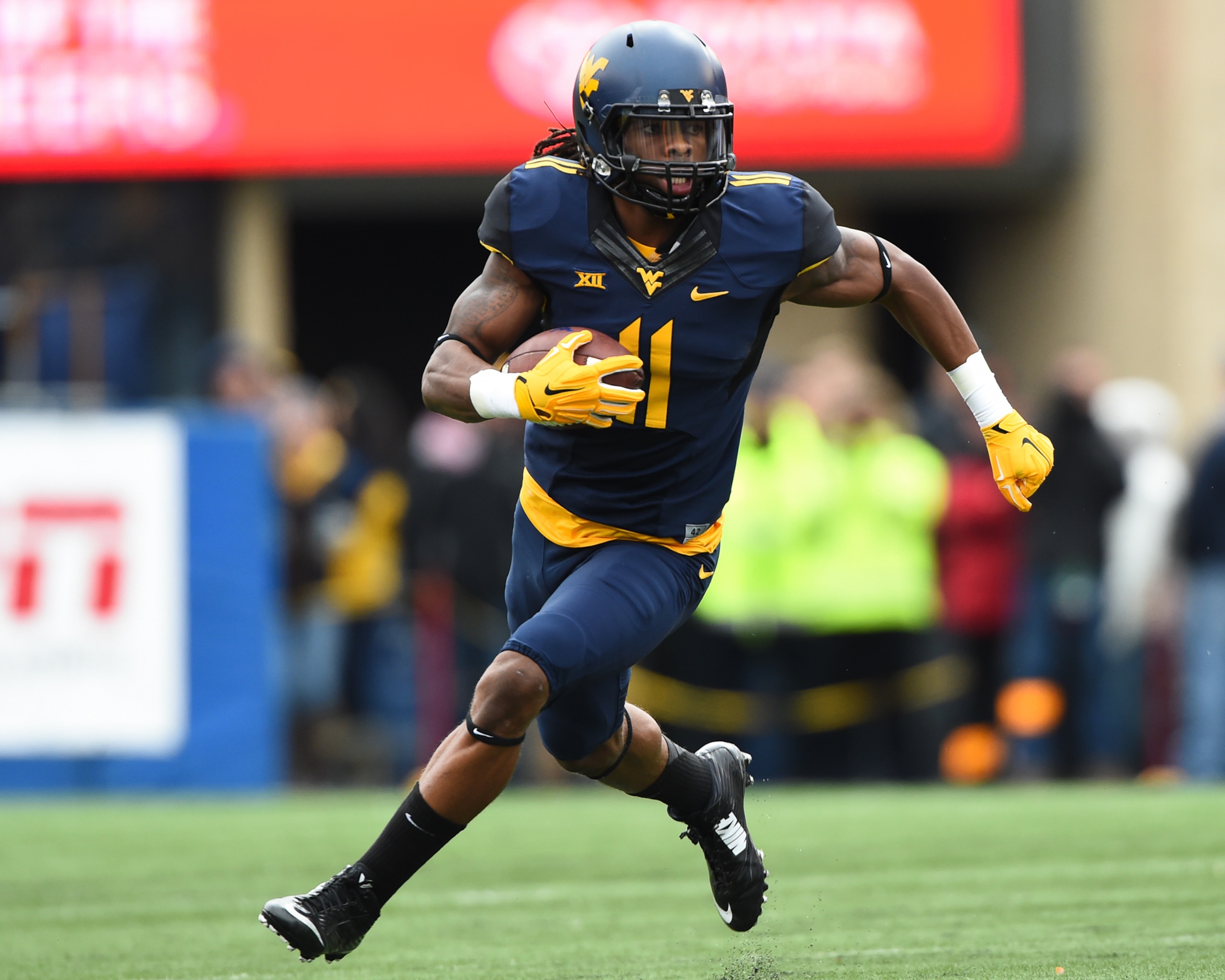 Nov 1, 2014; Morgantown, WV, USA; West Virginia Mountaineers wide receiver Kevin White (11) runs with ball after a catch during the first quarter against the TCU Horned Frogs at Milan Puskar Stadium. TCU Horned Frogs defeated West Virginia Mountaineers 31