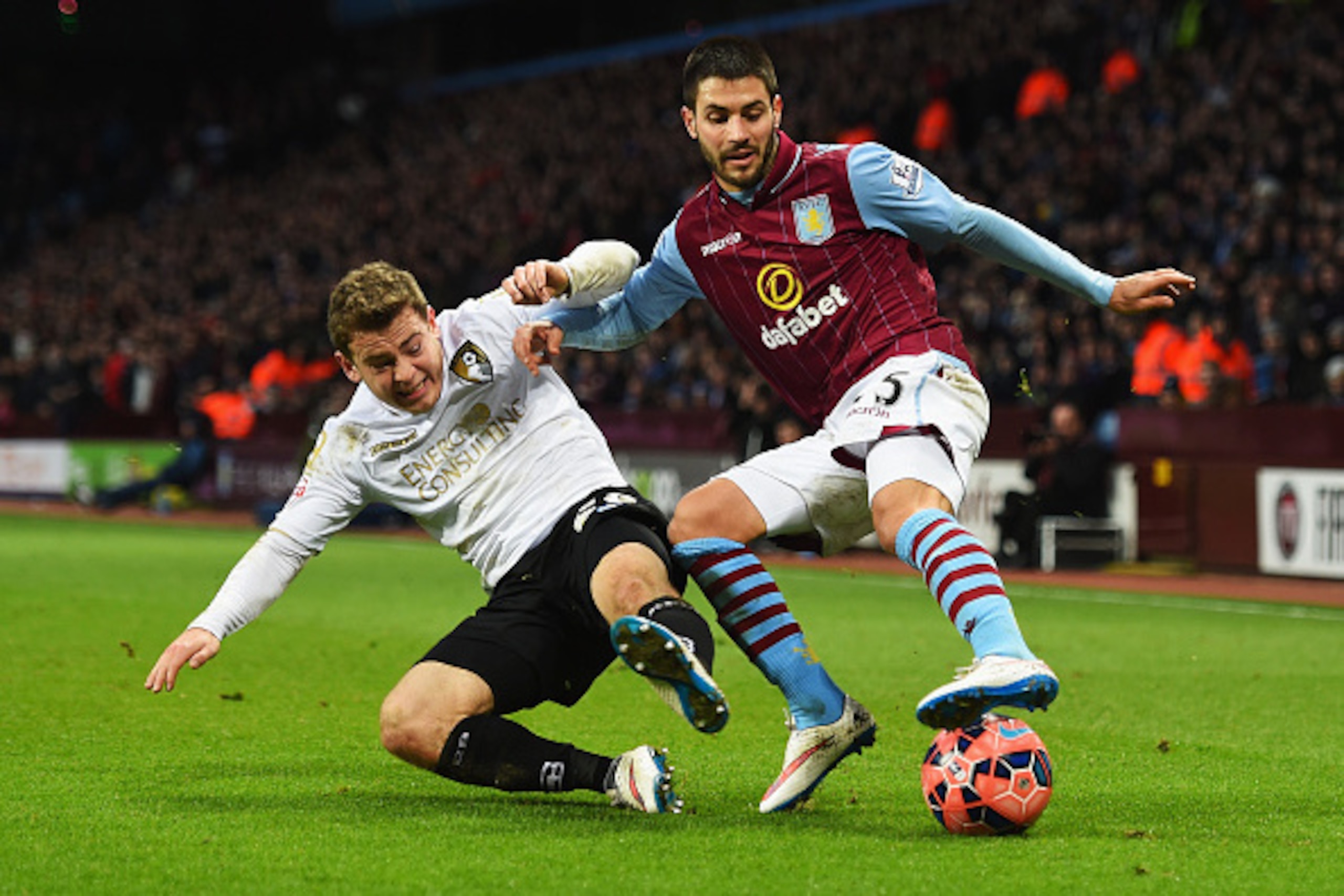 BIRMINGHAM, ENGLAND - JANUARY 25: Carles Gil of Aston Villa is tackled by Ryan Fraser of Bournemouth during the FA Cup Fourth Round match between Aston Villa and AFC Bournemouth at Villa Park on January 25, 2015 in Birmingham, England. (Photo by Shaun Bo BIRMINGHAM, ENGLAND - JANUARY 25: Carles Gil of Aston Villa is tackled by Ryan Fraser of Bournemouth during the FA Cup Fourth Round match between Aston Villa and AFC Bournemouth at Villa Park on January 25, 2015 in Birmingham, England. (Photo by Shaun Bo