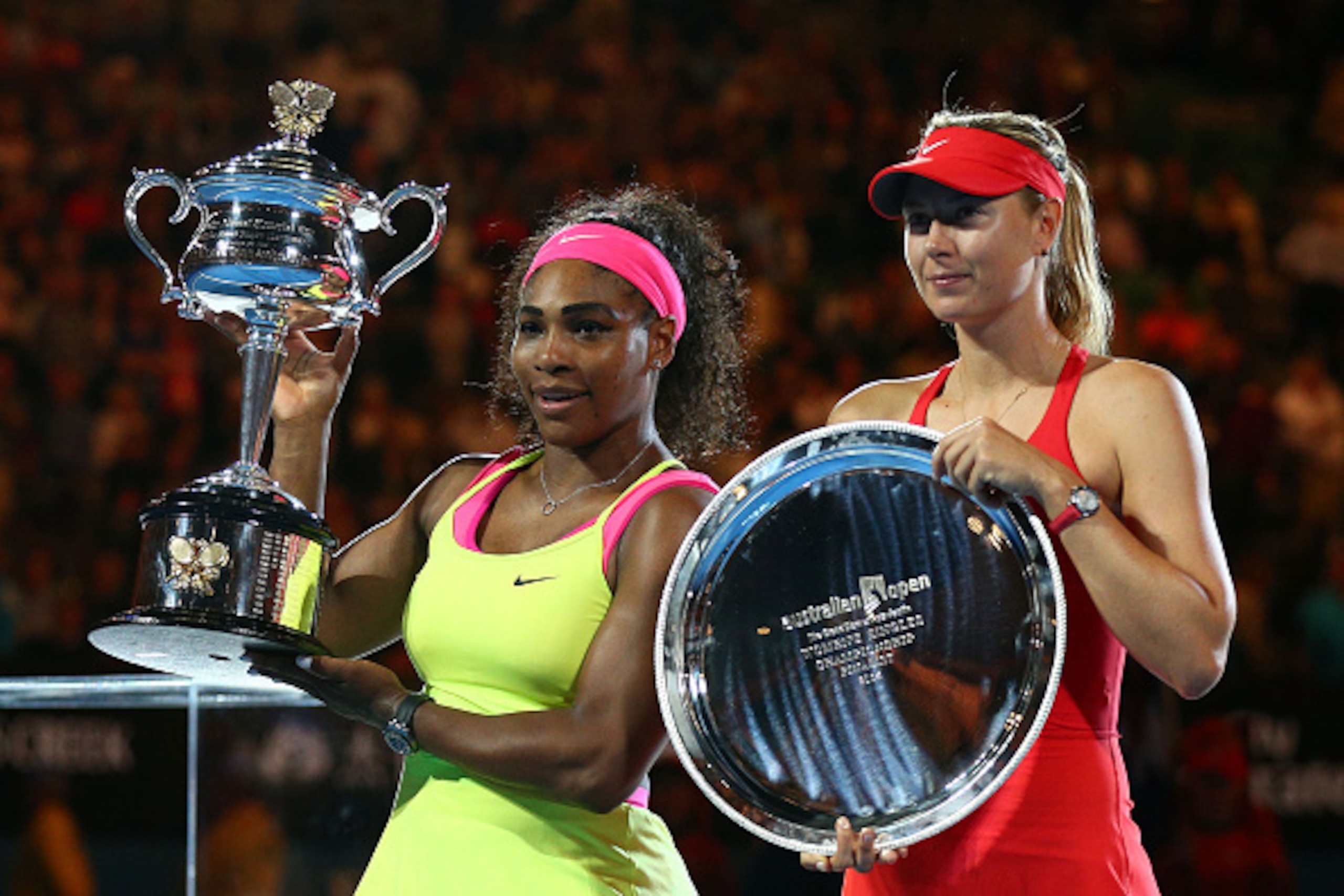 MELBOURNE, AUSTRALIA - JANUARY 31:  Serena Williams of the United States holds the Daphne Akhurst Memorial Cup and Maria Sharapova of Russia holds the runner up plate after their women's final match during day 13 of the 2015 Australian Open at Melbourne P