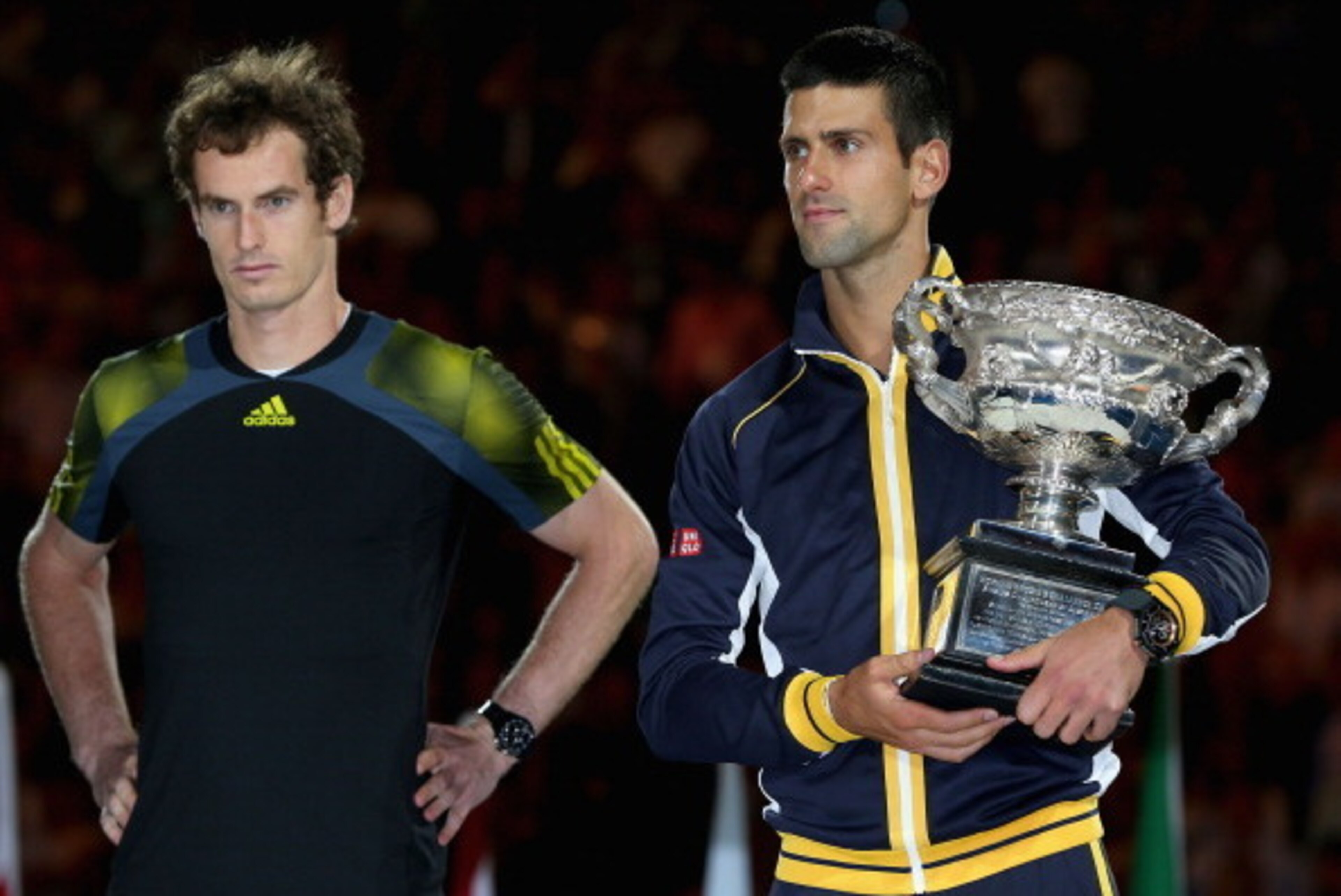 MELBOURNE, AUSTRALIA - JANUARY 27:  Andy Murray of Great Britain (L) watches Novak Djokovic of Serbia hold the Norman Brookes Challenge Cup after Djokovic won their men's final match during day fourteen of the 2013 Australian Open at Melbourne Park on Jan
