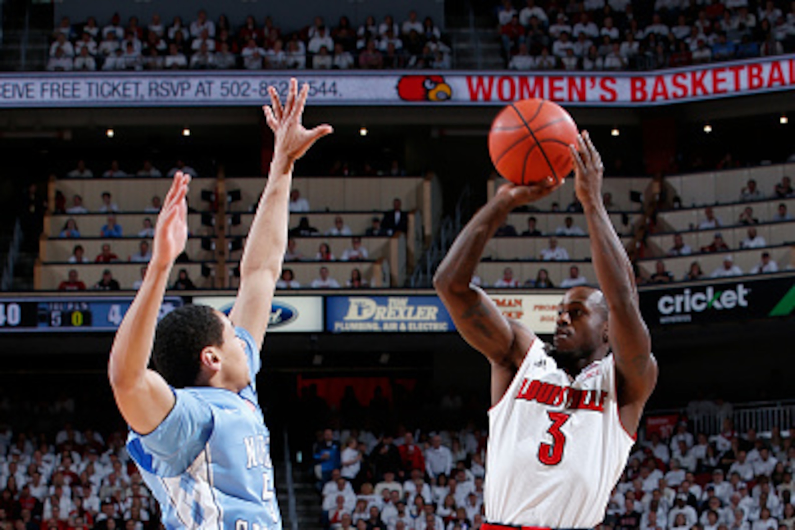 LOUISVILLE, KY - JANUARY 31: Chris Jones #3 of the Louisville Cardinals shoots the ball while defended by Marcus Paige #5 of the North Carolina Tar Heels during the first half of the game at KFC Yum! Center on January 31, 2015 in Louisville, Kentucky. (Ph