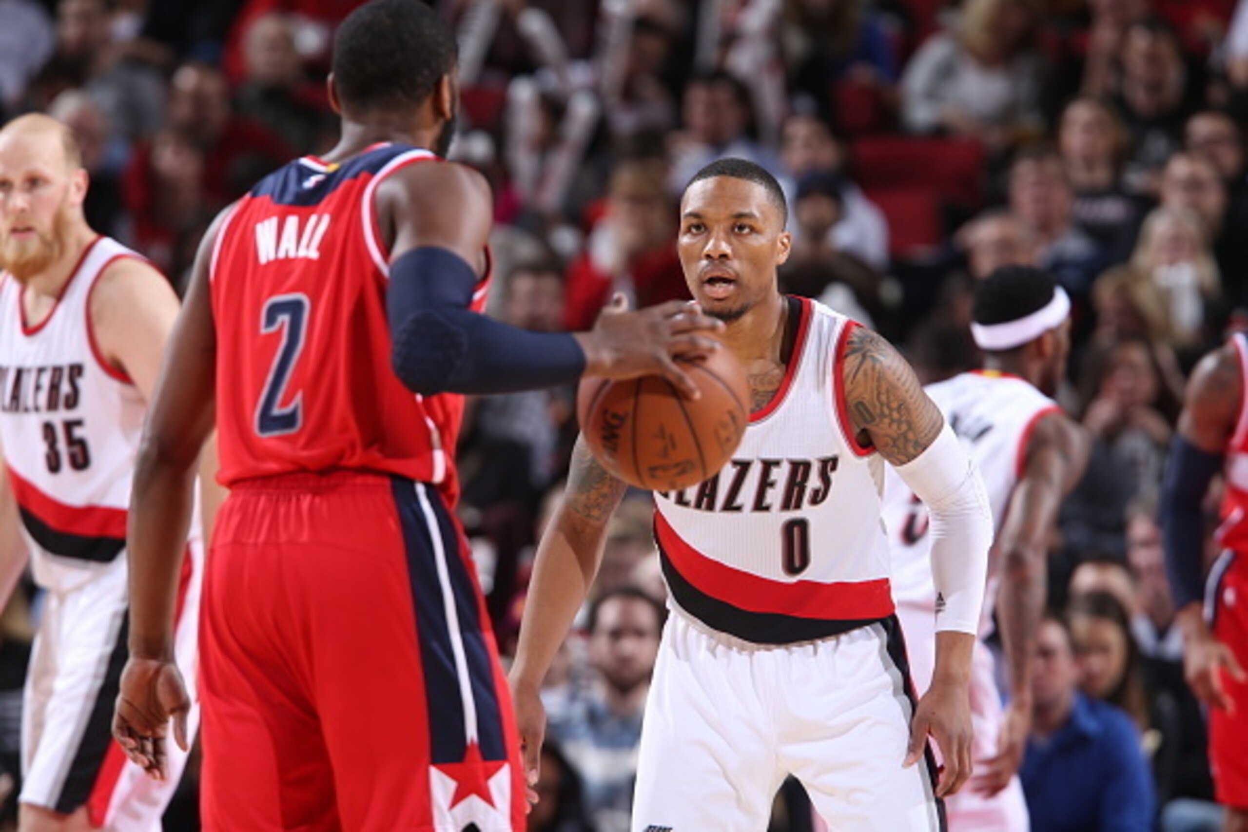 PORTLAND, OR - JANUARY 24:  Damian Lillard #0 of the Portland Trail Blazers defends against the Washington Wizards on January 24, 2015 at the Moda Center Arena in Portland, Oregon. NOTE TO USER: User expressly acknowledges and agrees that, by downloading 